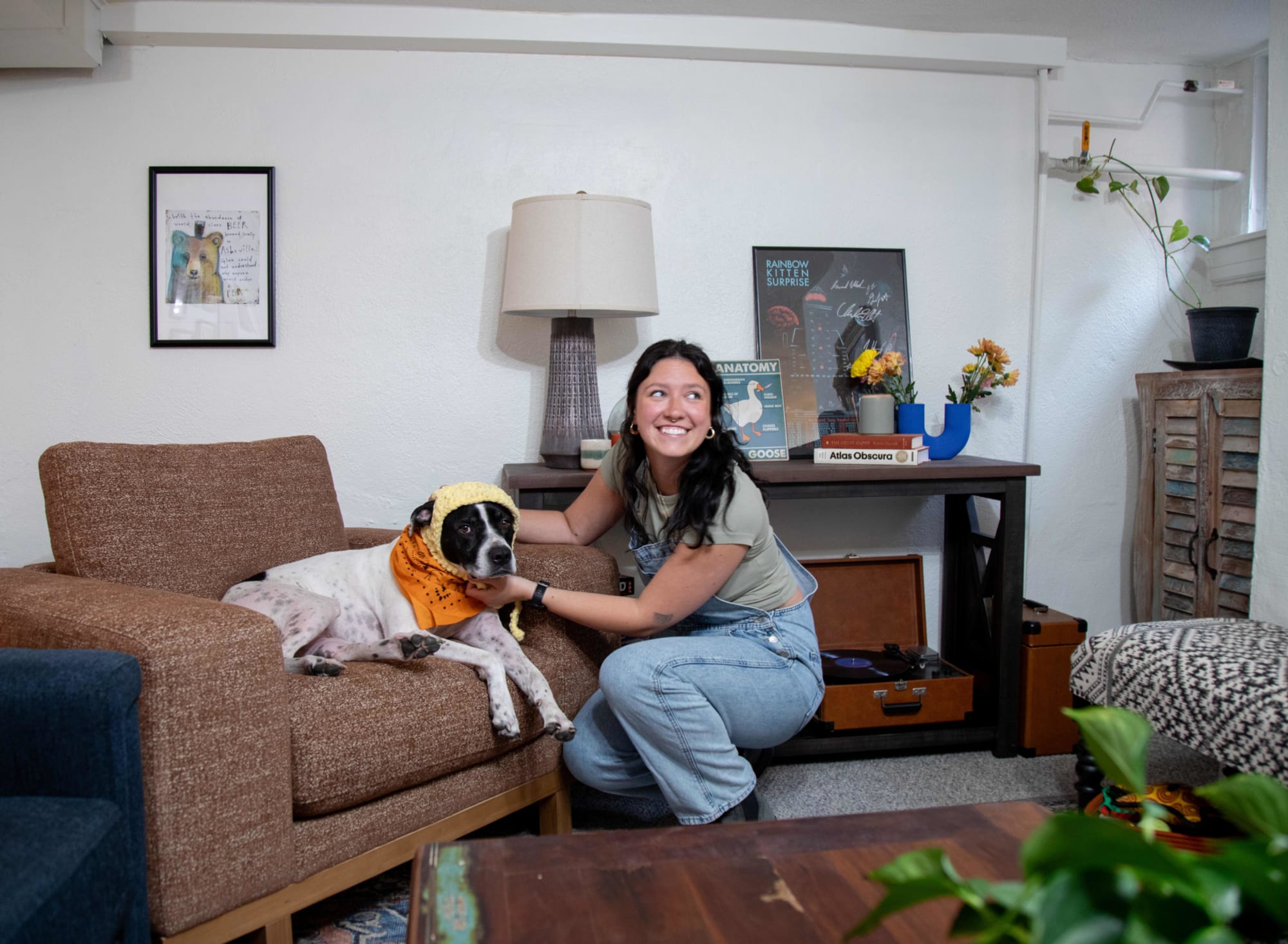 Shot of Mackinley with her dog posed in the Laguna Chair in her maximalist living oom