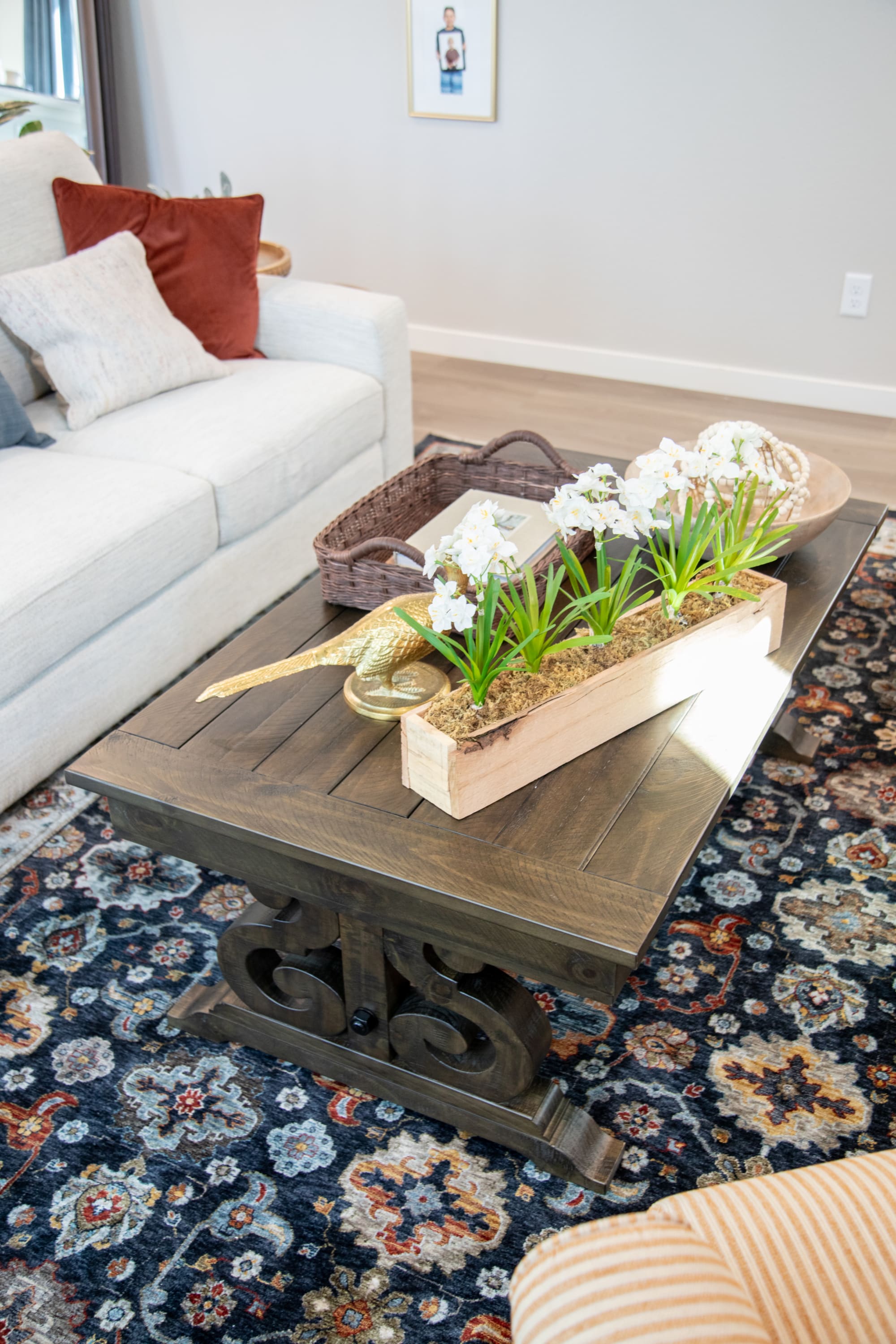 The Sedona Coffee Table, a wood coffee table, with flowers on top