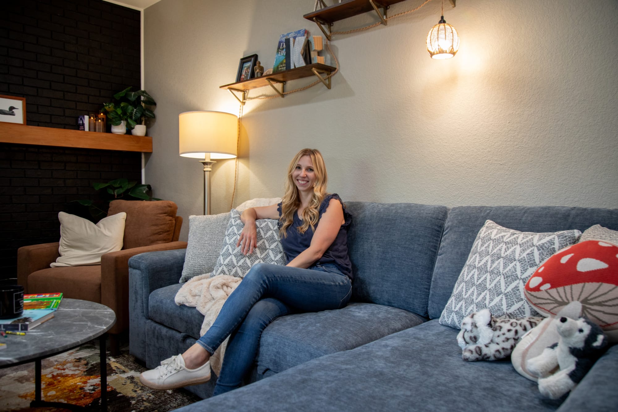 Kate sitting on the Noble Sectional styled for her modern living room