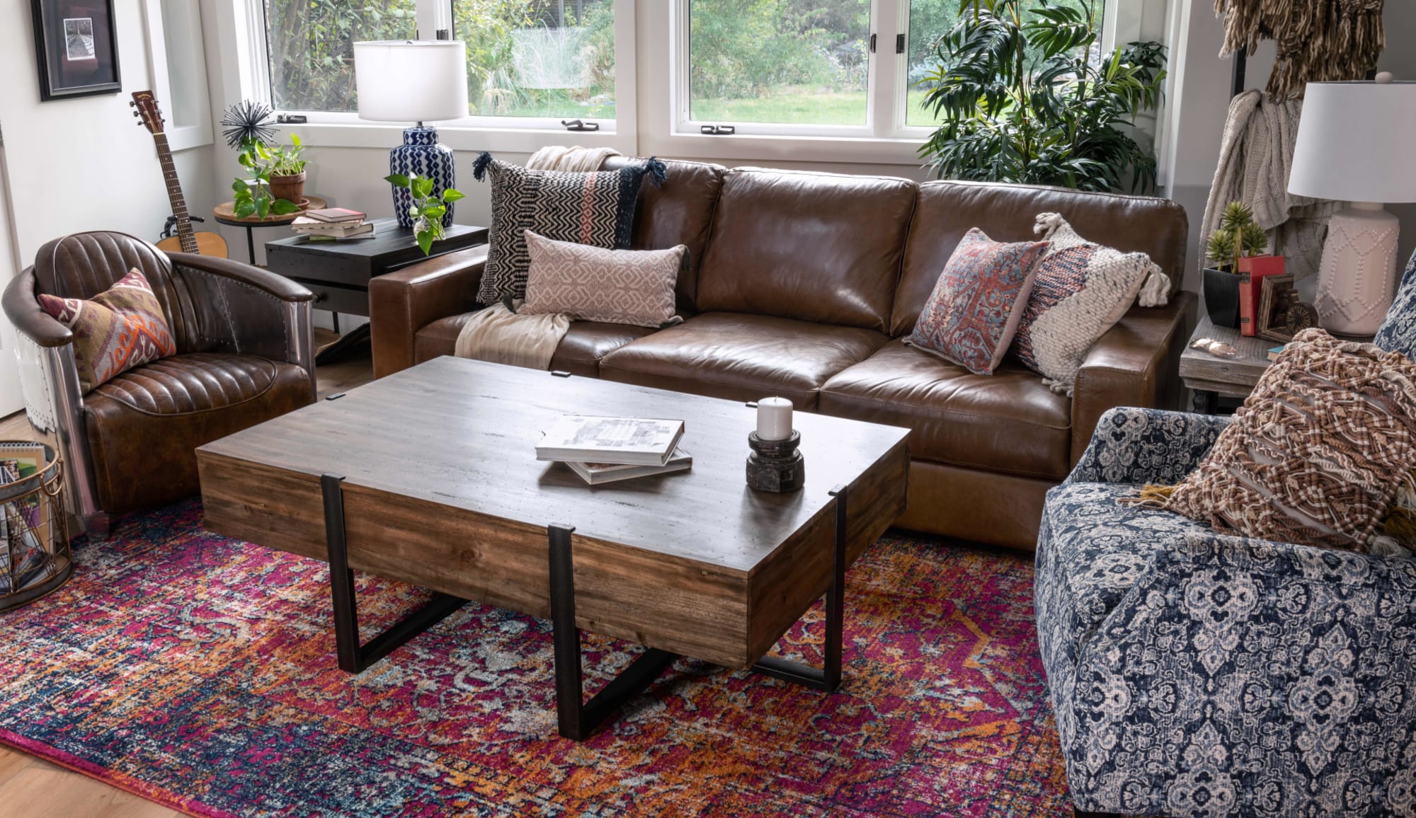 Brown leather sofa with brown leather club chair and coffee table in living room window shot
