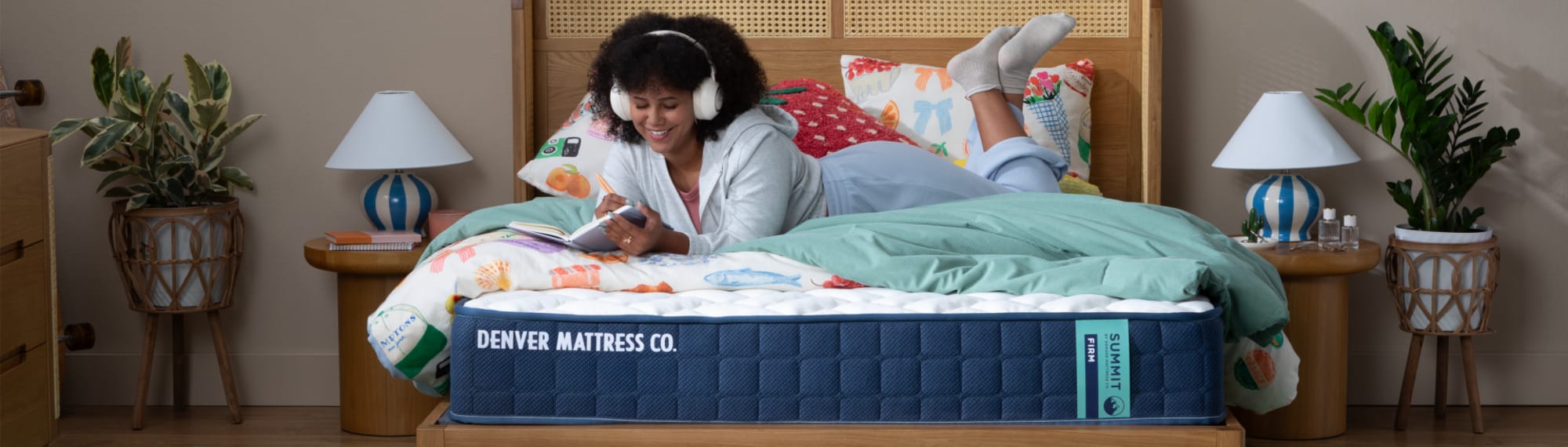 Woman Laying on Summit Factory Direct Mattress Journaling and Listening to Music