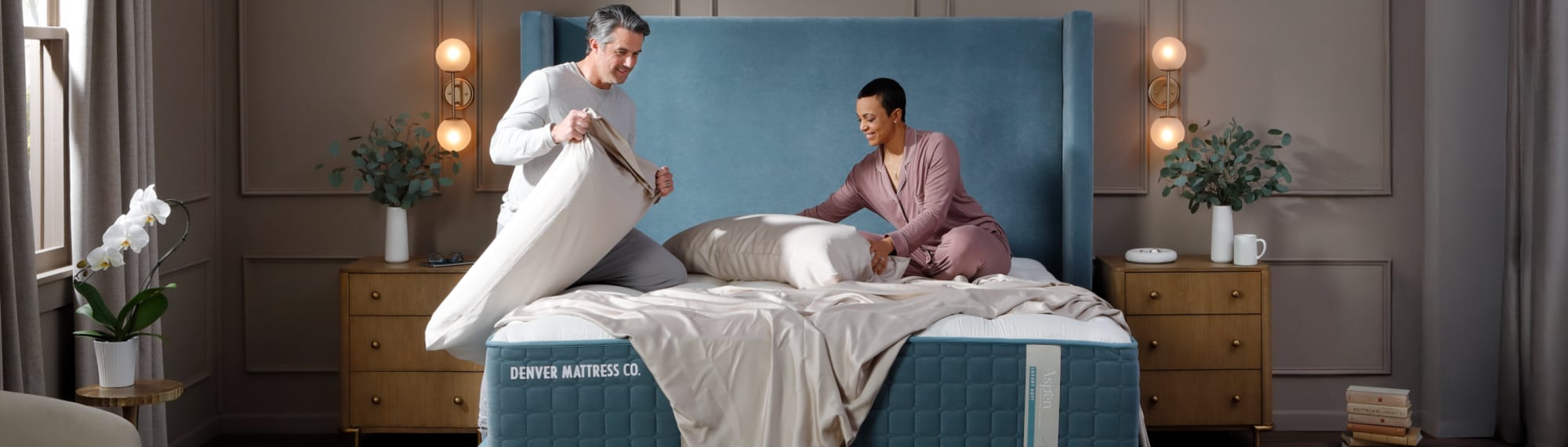 Couple making luxury bed in Bedroom