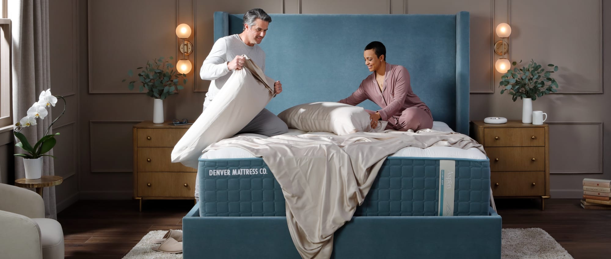 Couple making luxury bed in Bedroom