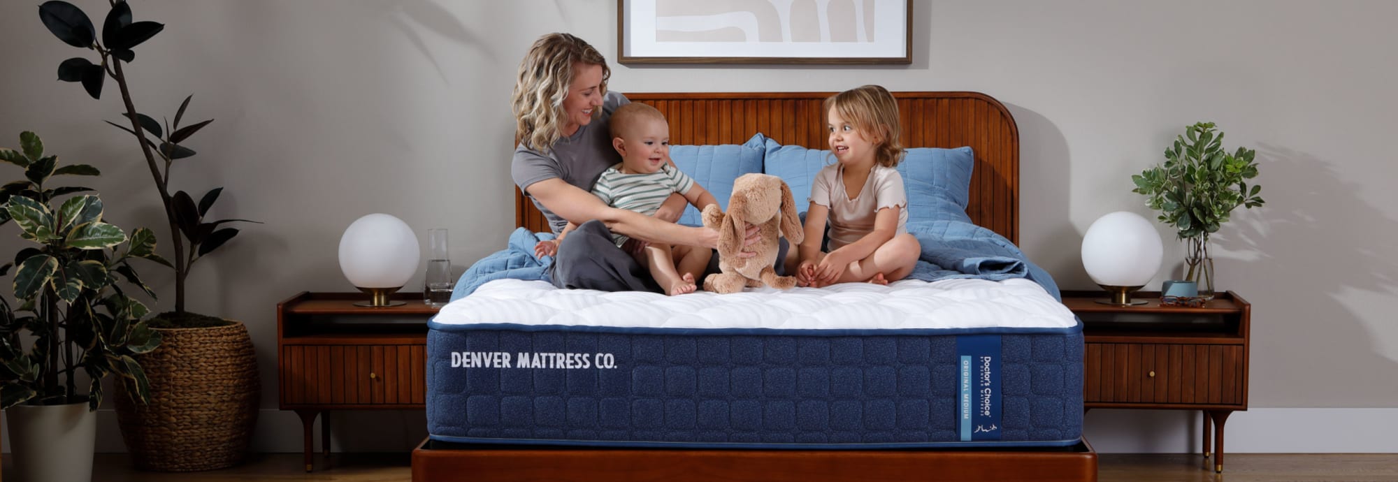 Family Sitting on Doctors Choice Medium Mattress in Bedroom