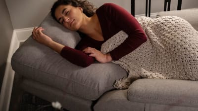 Woman Sleeping in Gray Reclining Chair