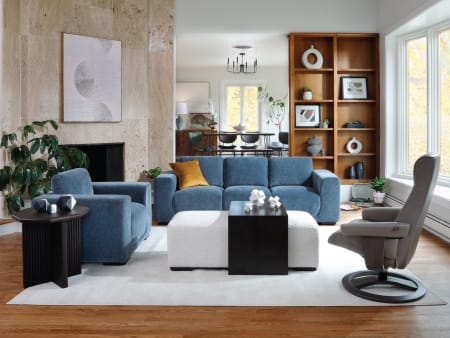 Wide room shot of the Jasper Sofa with a matching chair and leather accent chair