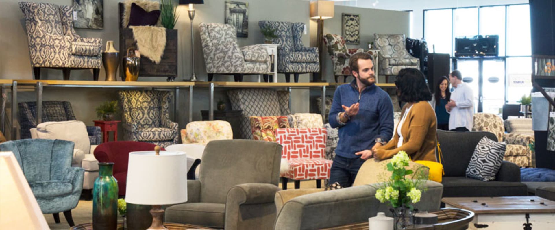 Couple Walking Through Large Chair Collection in Store