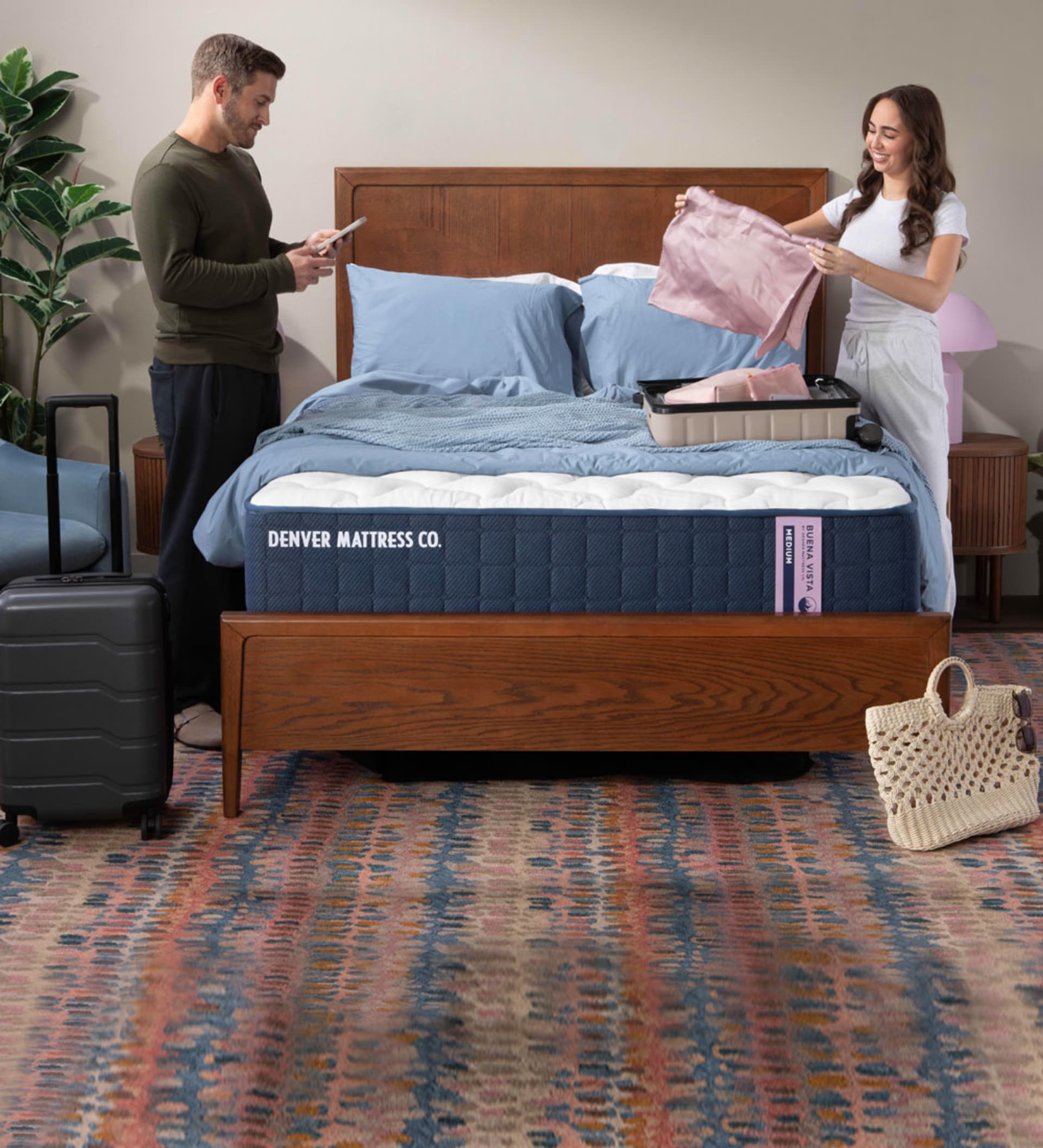 Couple Packing for a trip in bedroom with Buena Vista Mattress