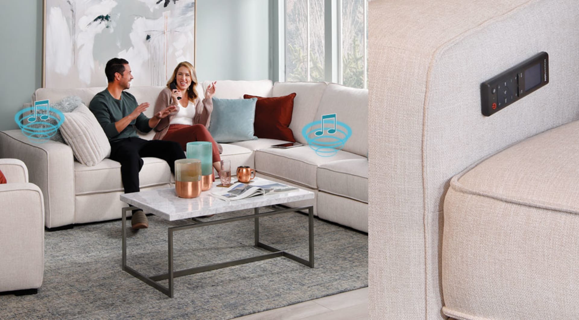Couple sitting on Gray sectional listening to music and dancing