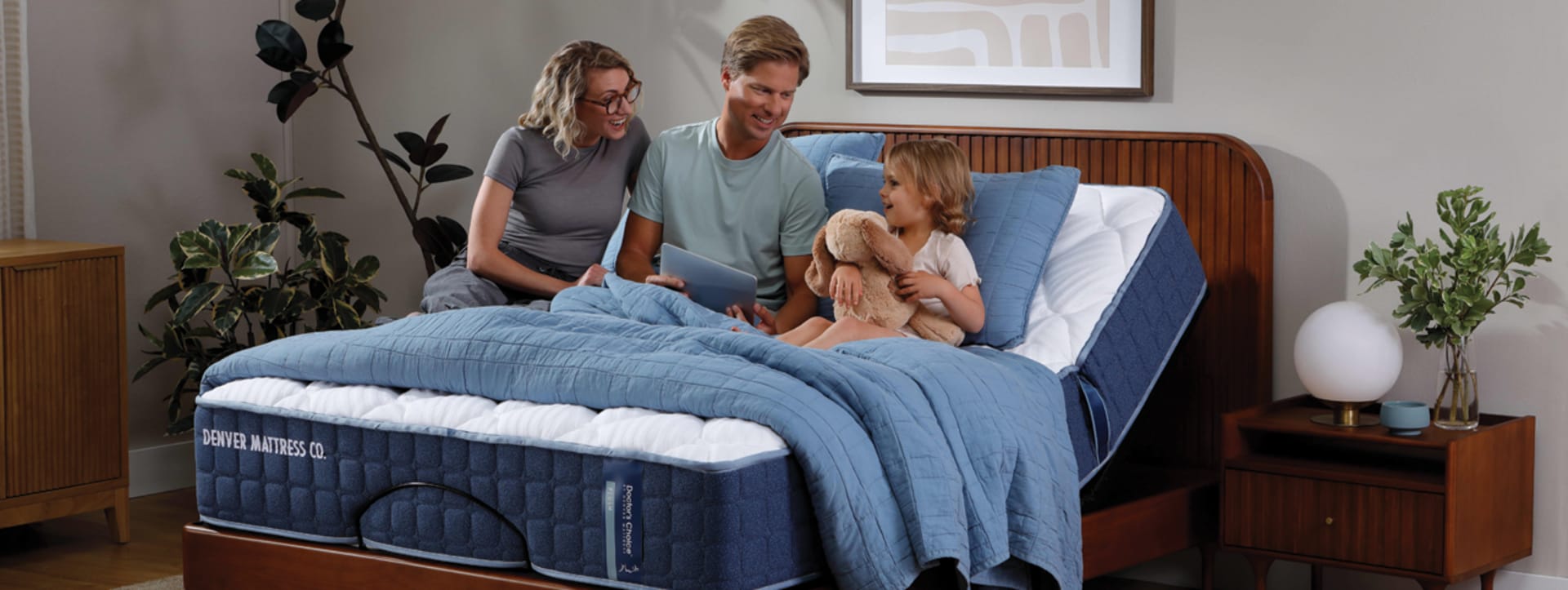 Family sitting on Doctor's Choice Original Mattress on Adjustable base reading a book