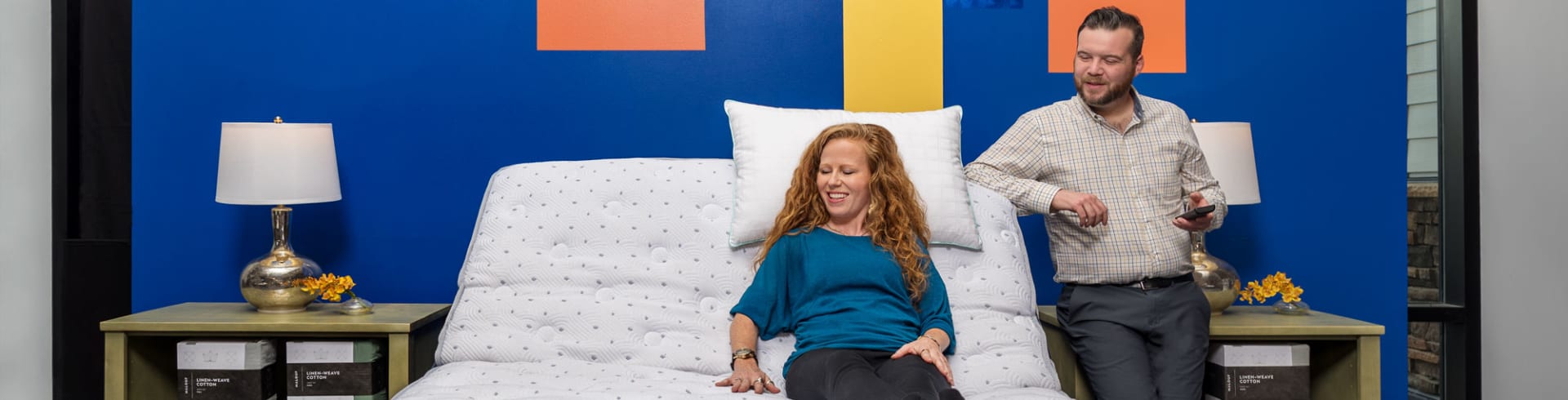 Couple testing adjustable base in denver mattress store