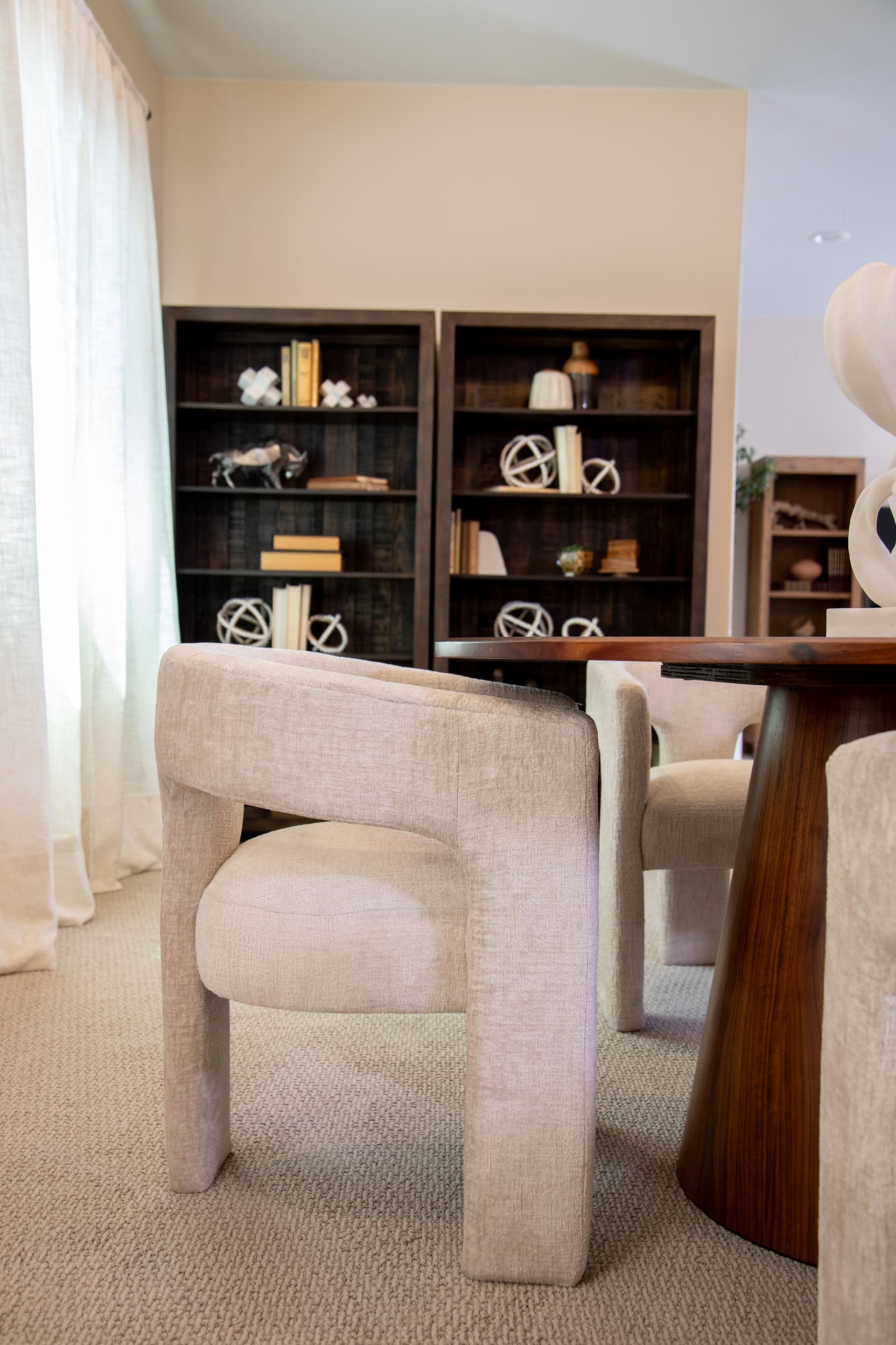 The neutral Nash Dining Chair at a table