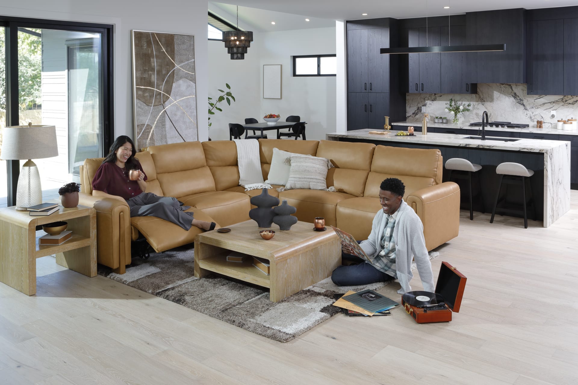 Camel Colored leather sectional with light wood accents in living room