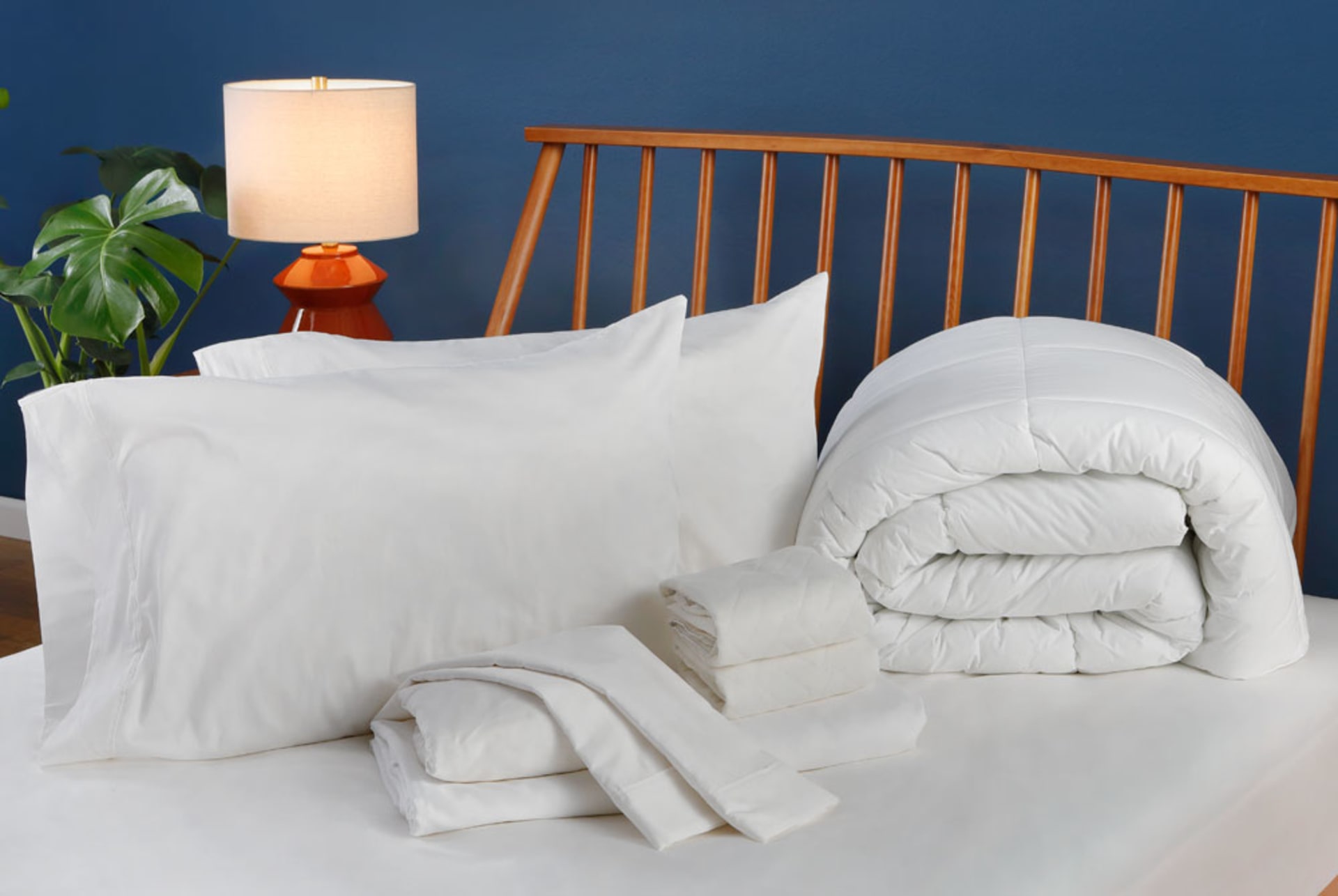 Collection of Sheets and Accessories on top of Mattress