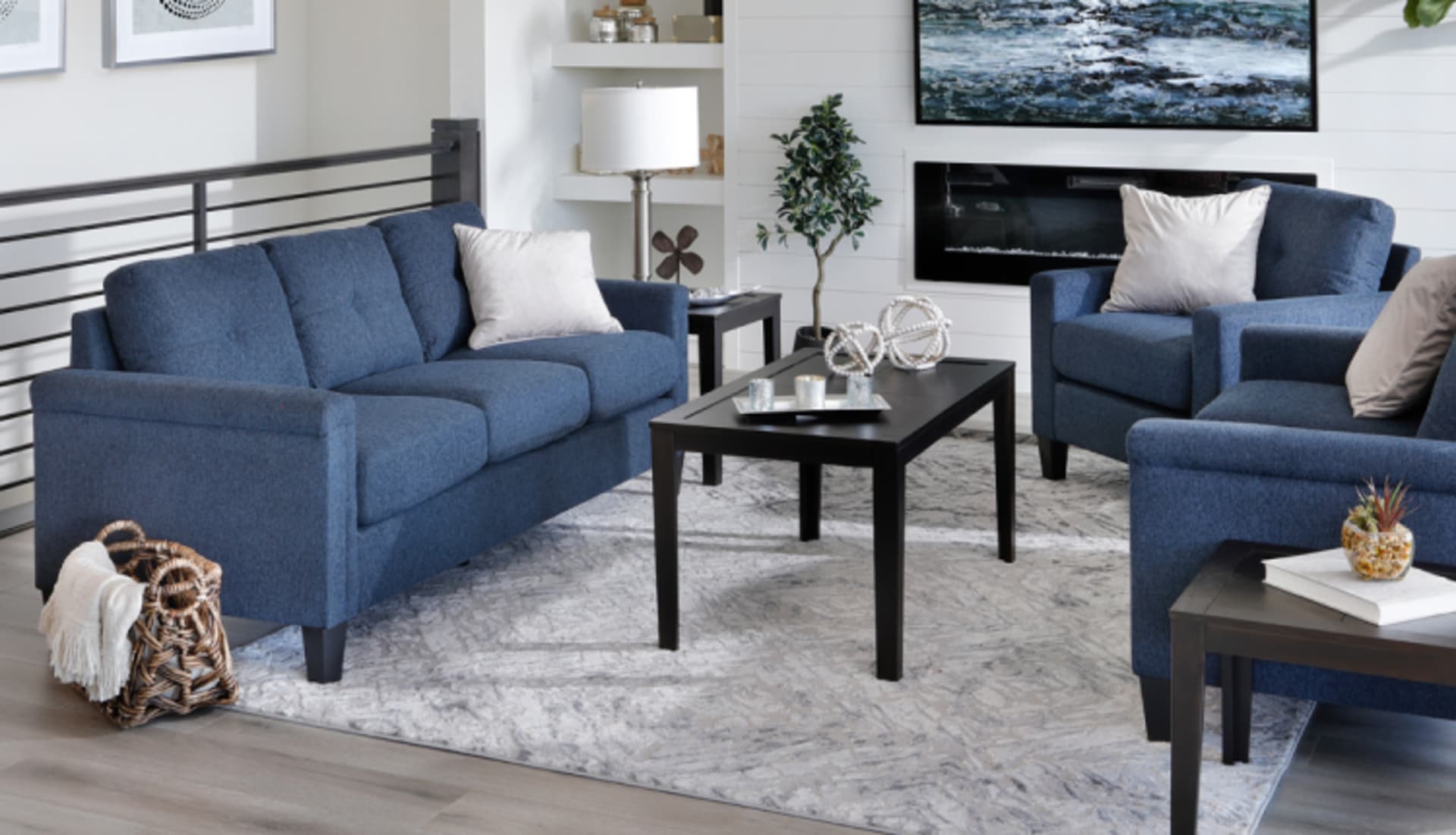 Blue Padded Arm Sofa in a living room with matching chairs