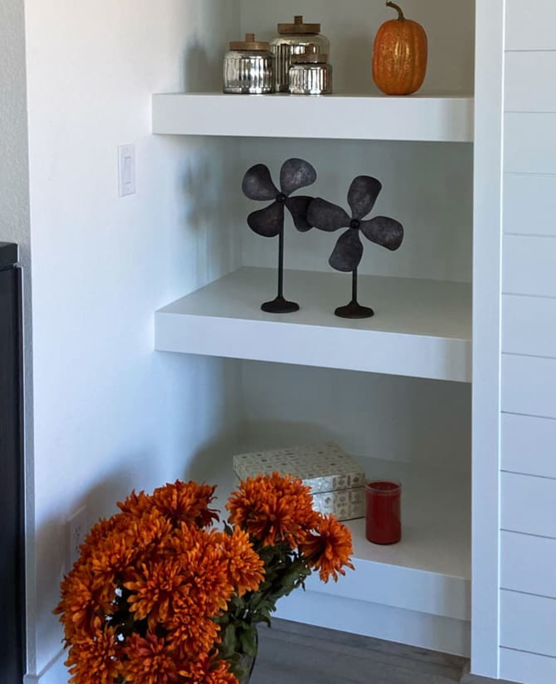 Bookshelf decorated for fall