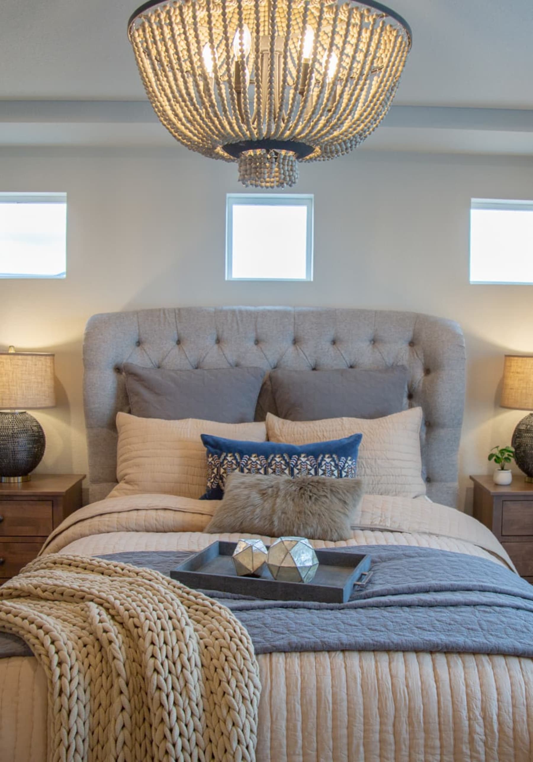 Gray button tufted upholstered bed in bedroom