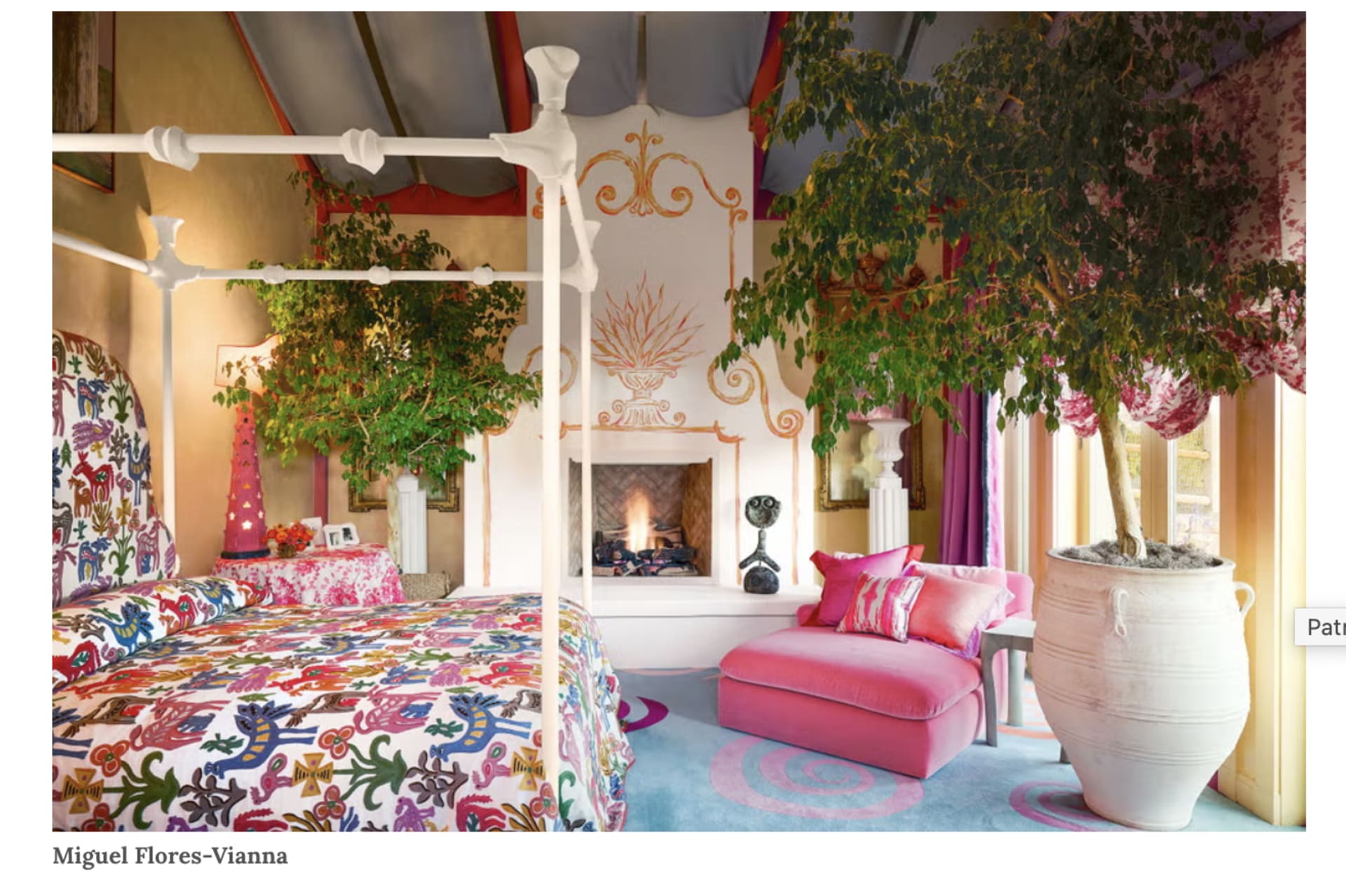 An Example Dopamine Decor Room with vibrant bedding and a pink accent chair