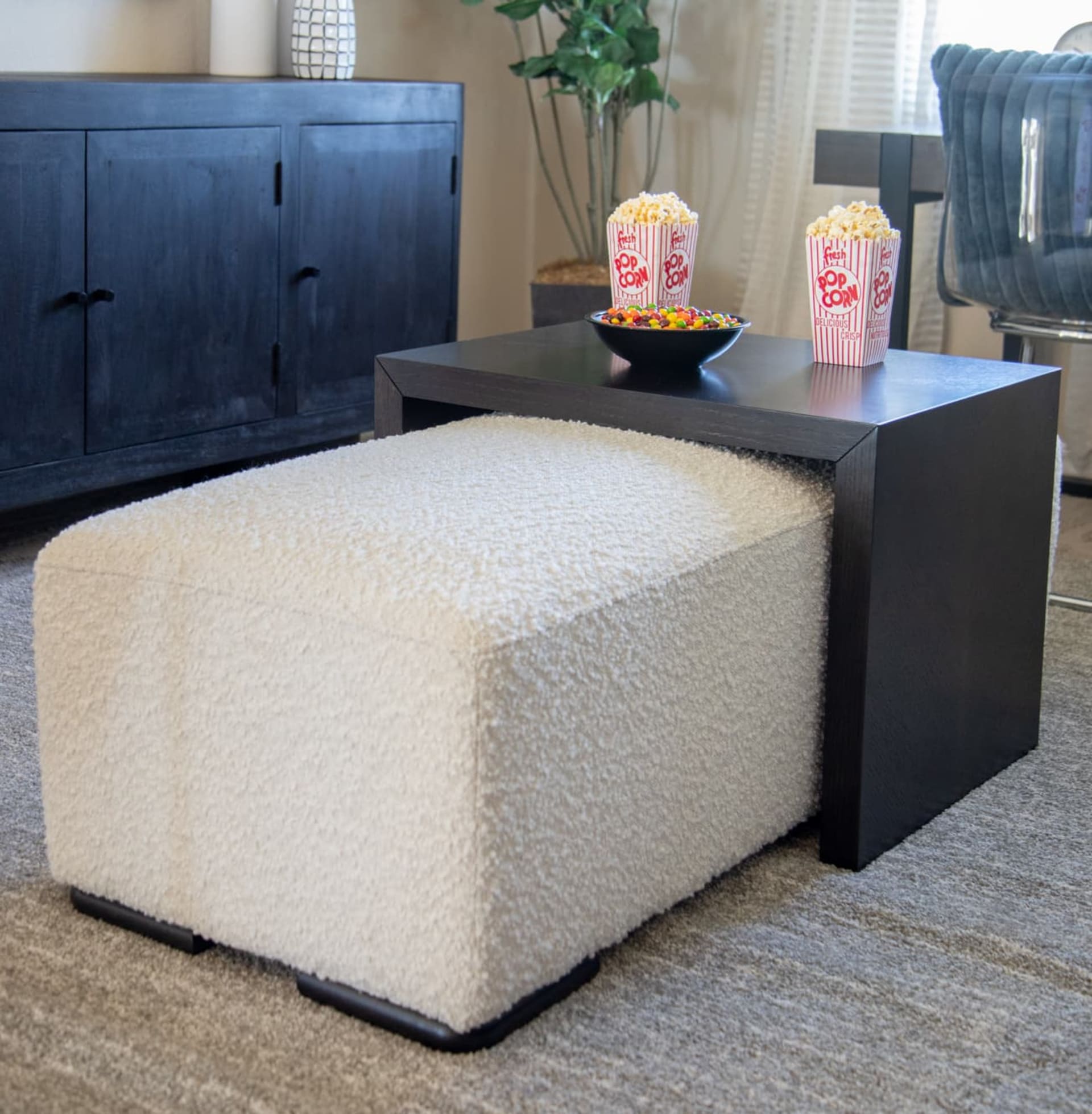 Room shot of the multifunctional Jasper Ottoman, which also comes with a black table to hold snacks