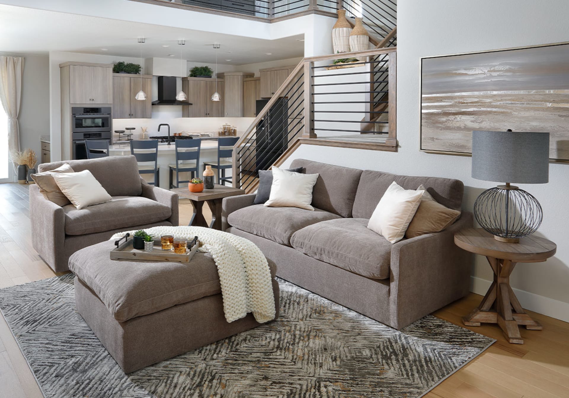 Modern taupe sofa accompanied by matching chair and ottoman in living room
