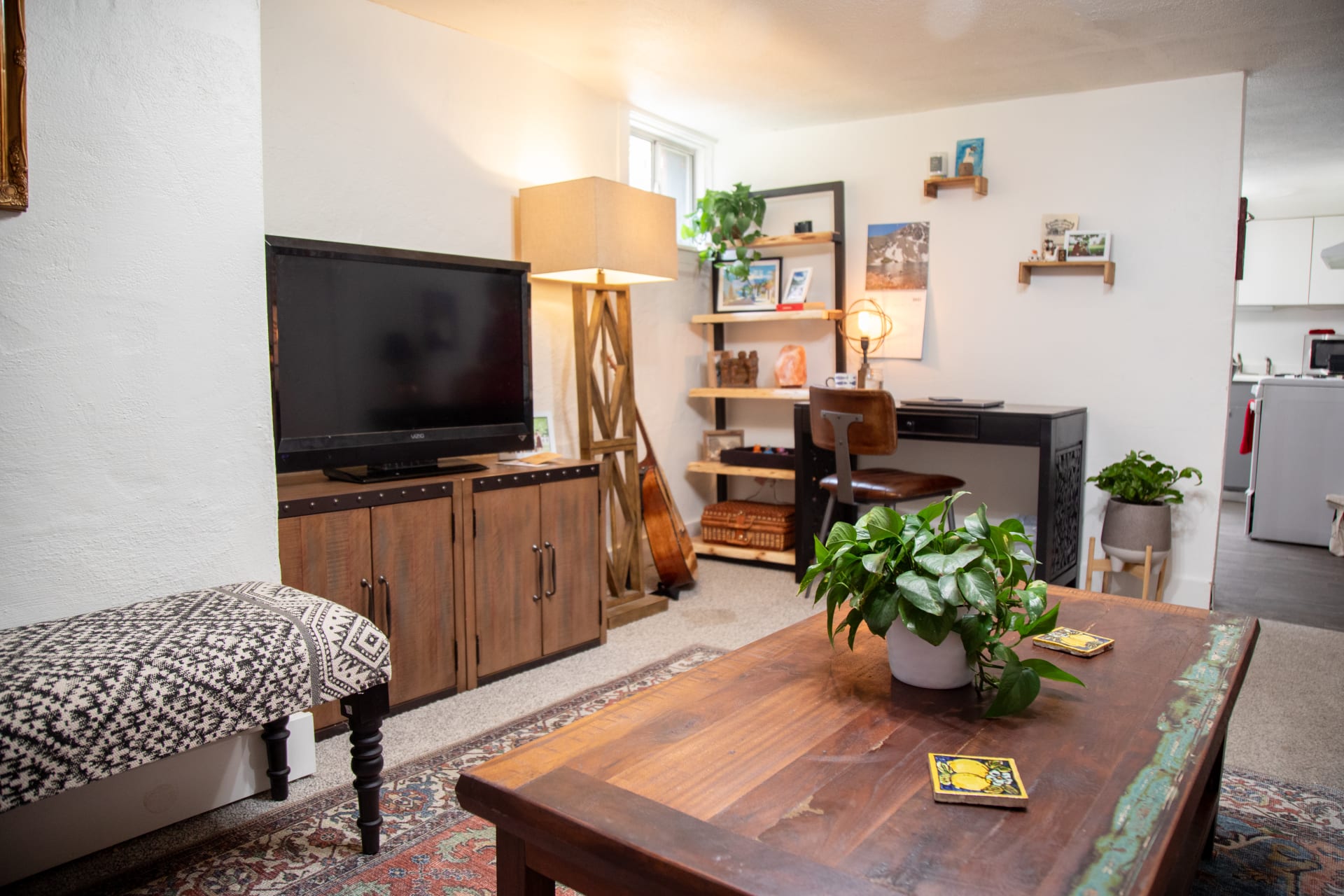 The Antiqua Coffee Table styled in Mackinley's apartment living room
