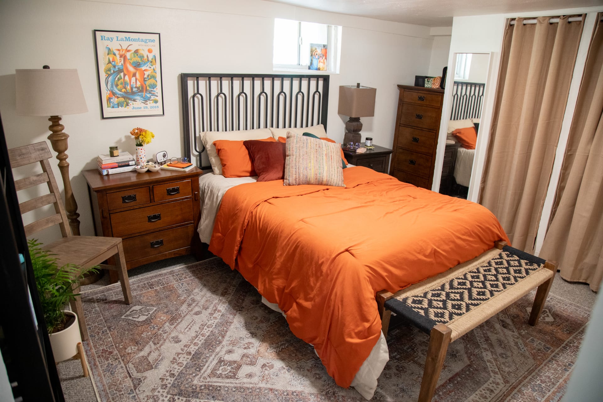The Miura Metal Bed styled in Mackinley's apartment bedroom with two mismatched nightstands