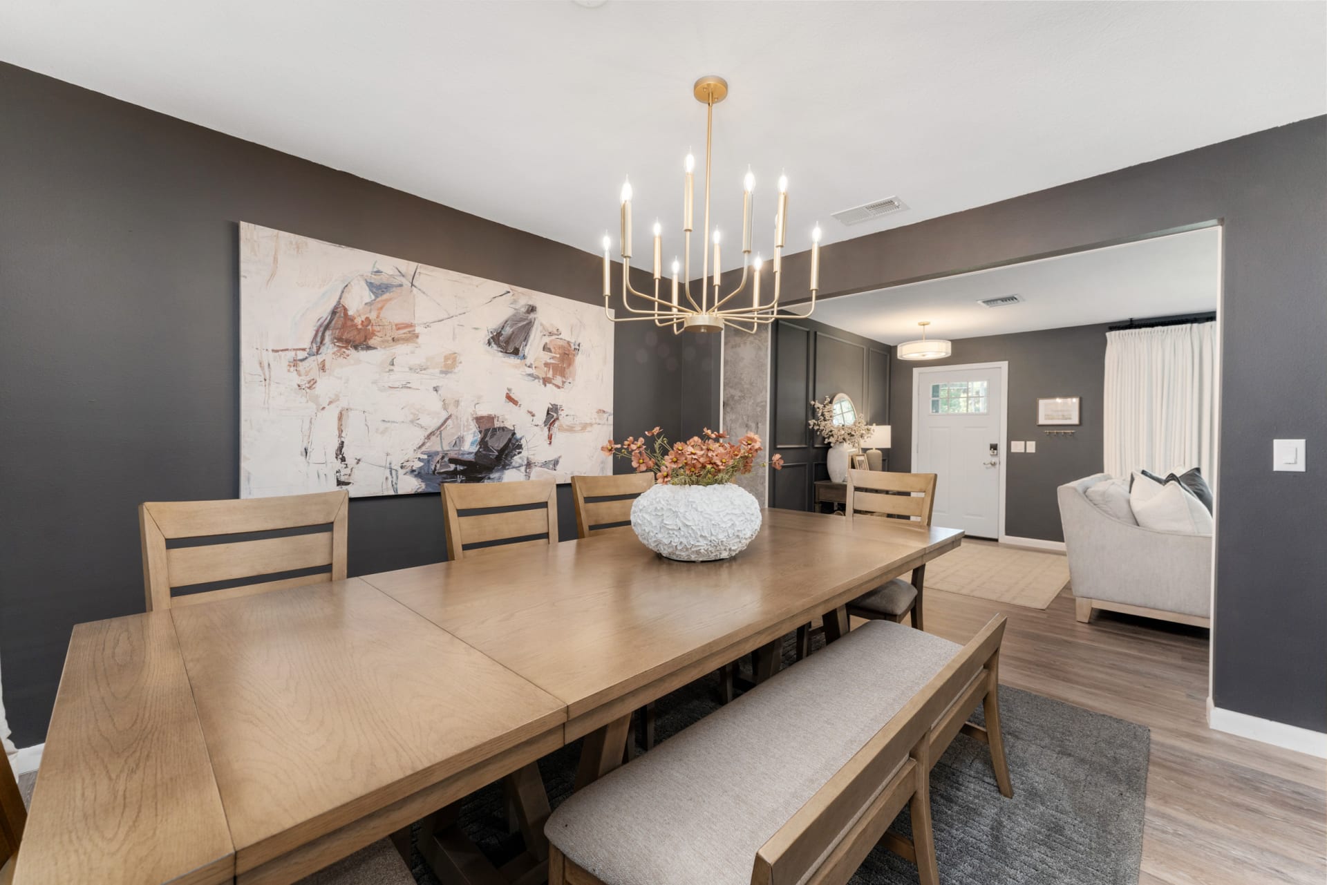 Angled corner shot of modern wood dining set in Kelli Bateman's Airbnb dining room