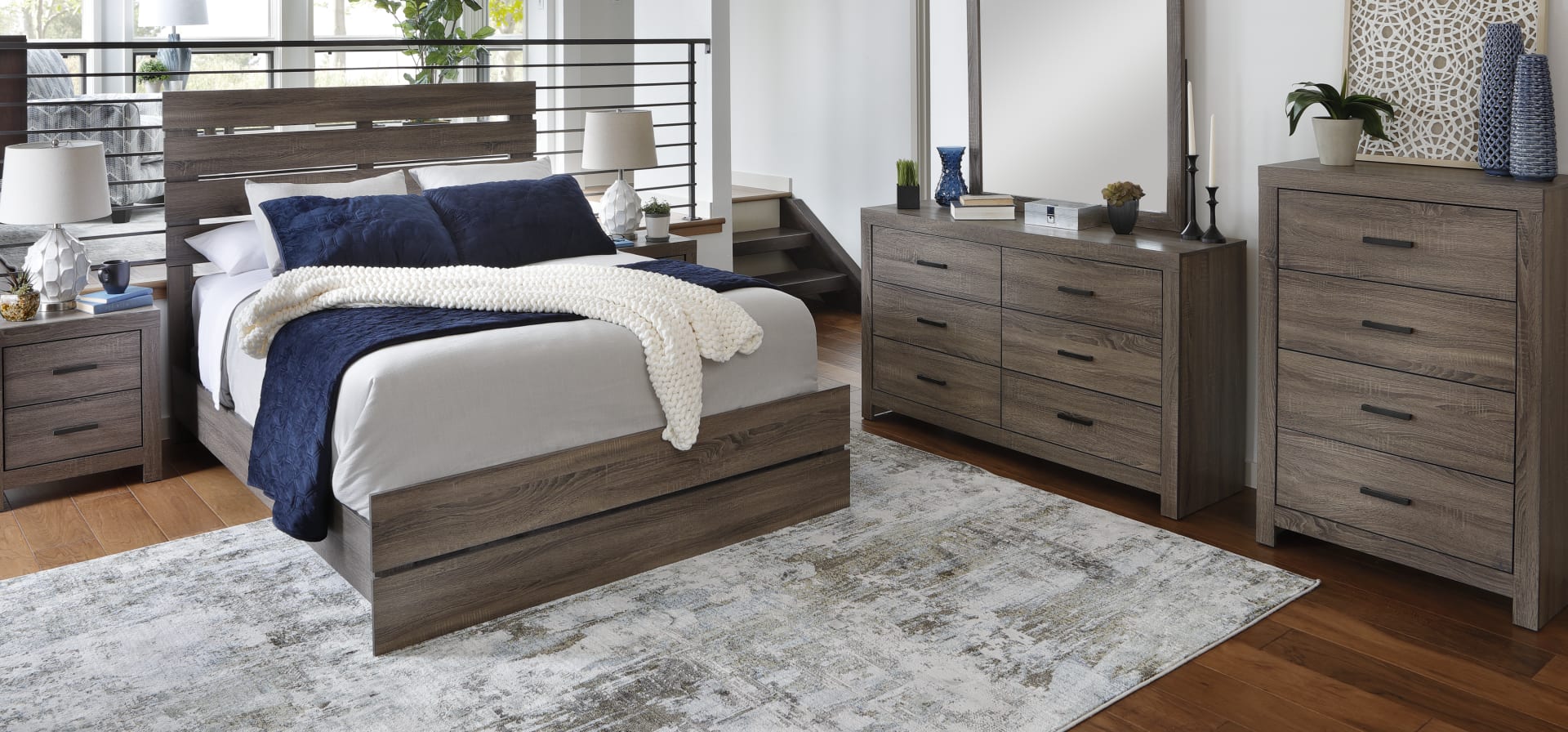 Wingate Queen Size Bed. Slat-backed panel bedframe with greyish brown wood.