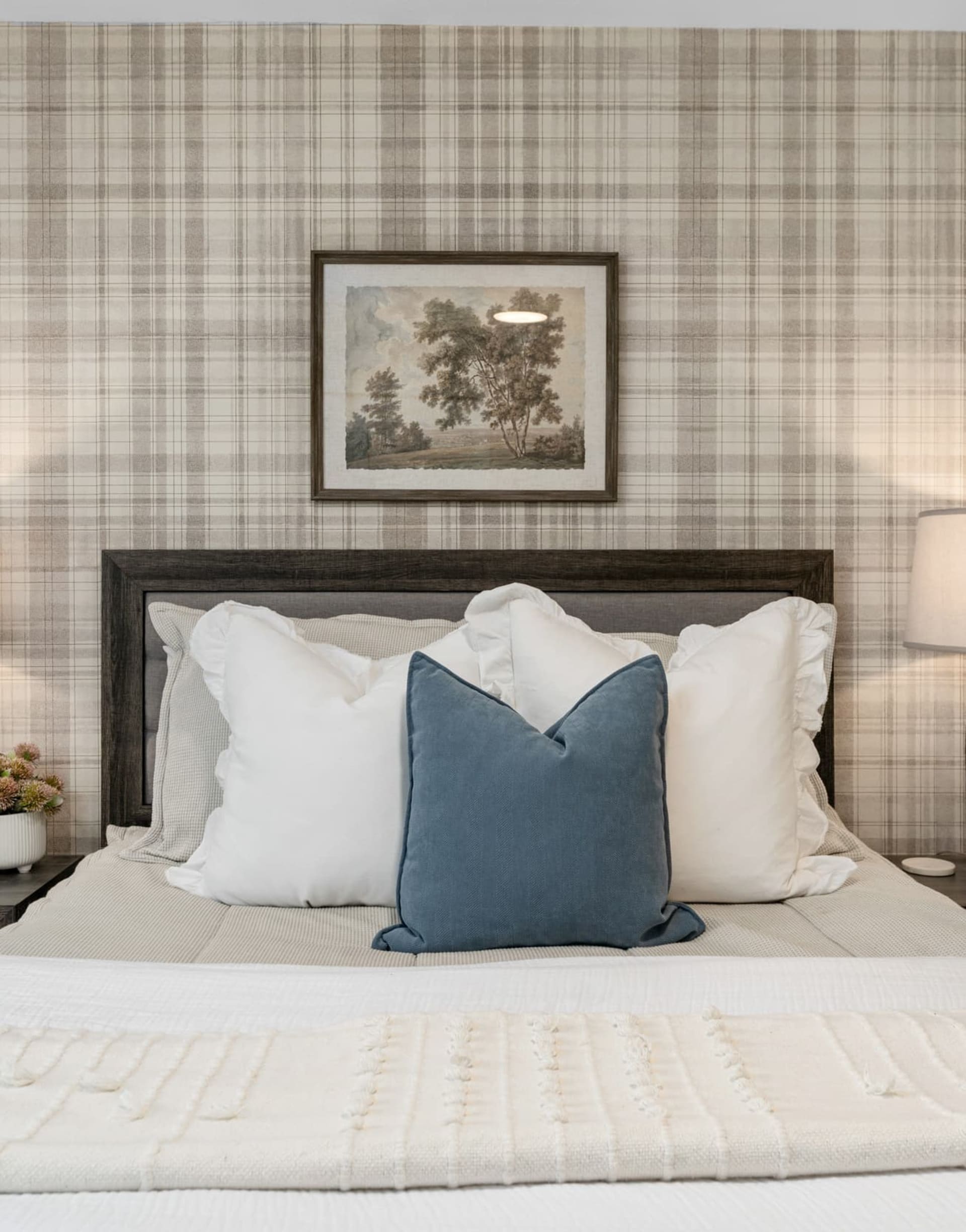 Closeup of upholstered panel bed in Kelli Bateman's Airbnb third bedroom