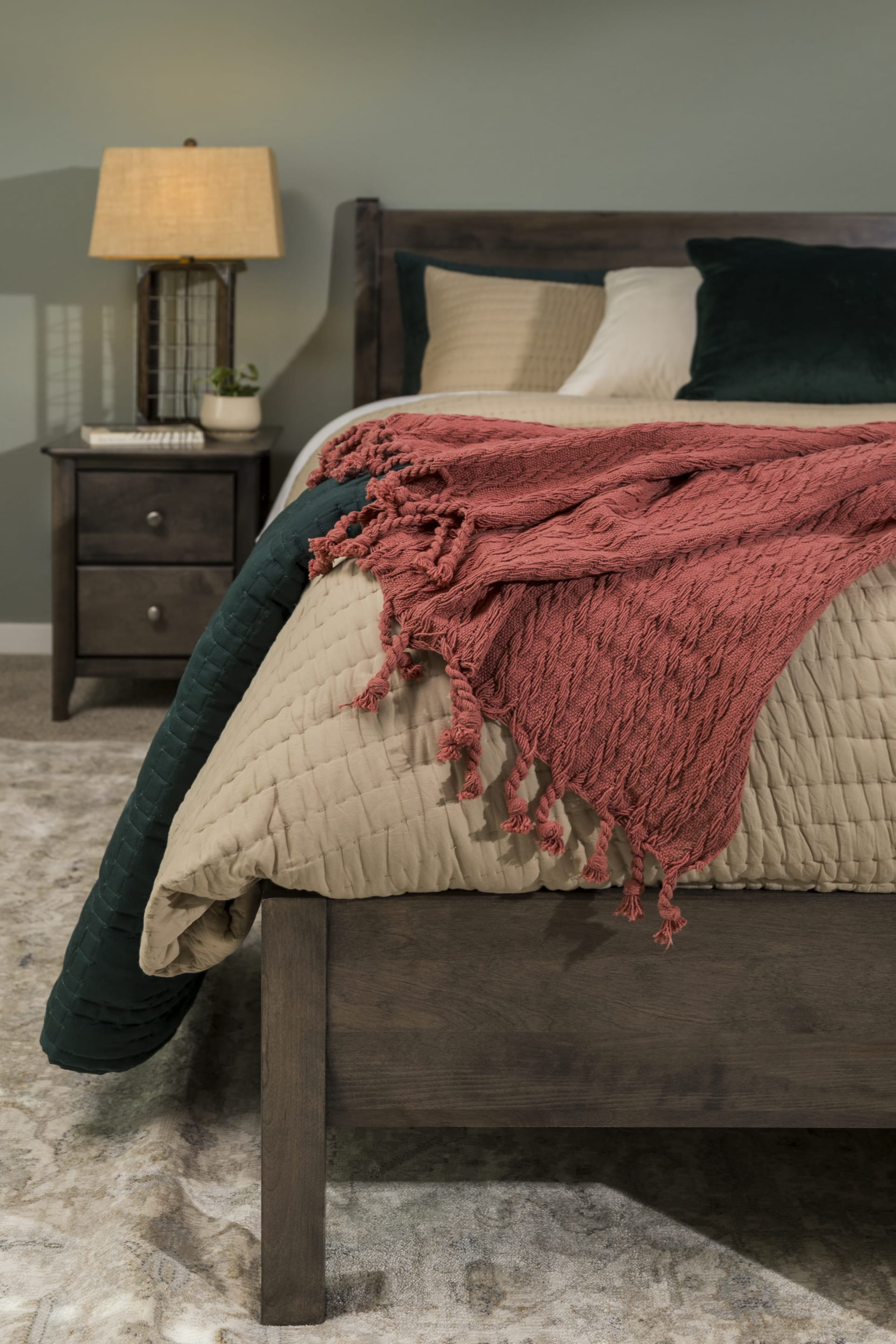 Cool-toned brown solid wood platform bed and matching nightstand in bedroom