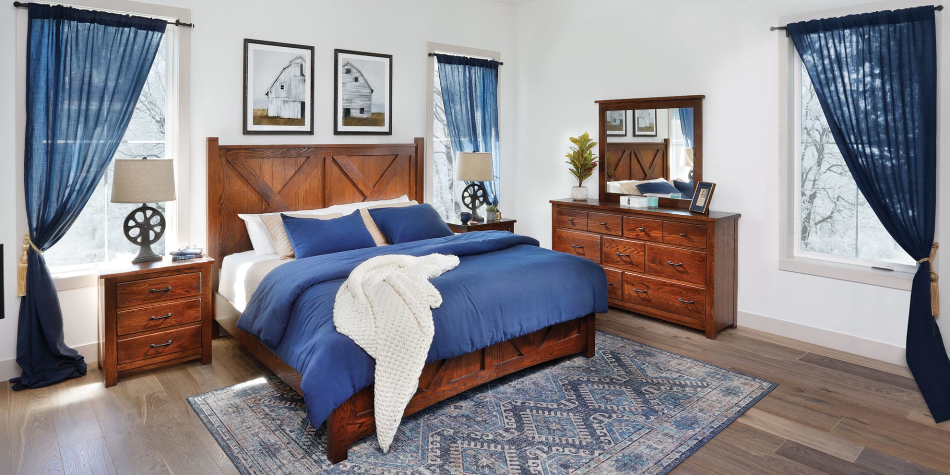 Rich wood bedroom set featuring a panel bed, nightstand, dresser, and wall mirror