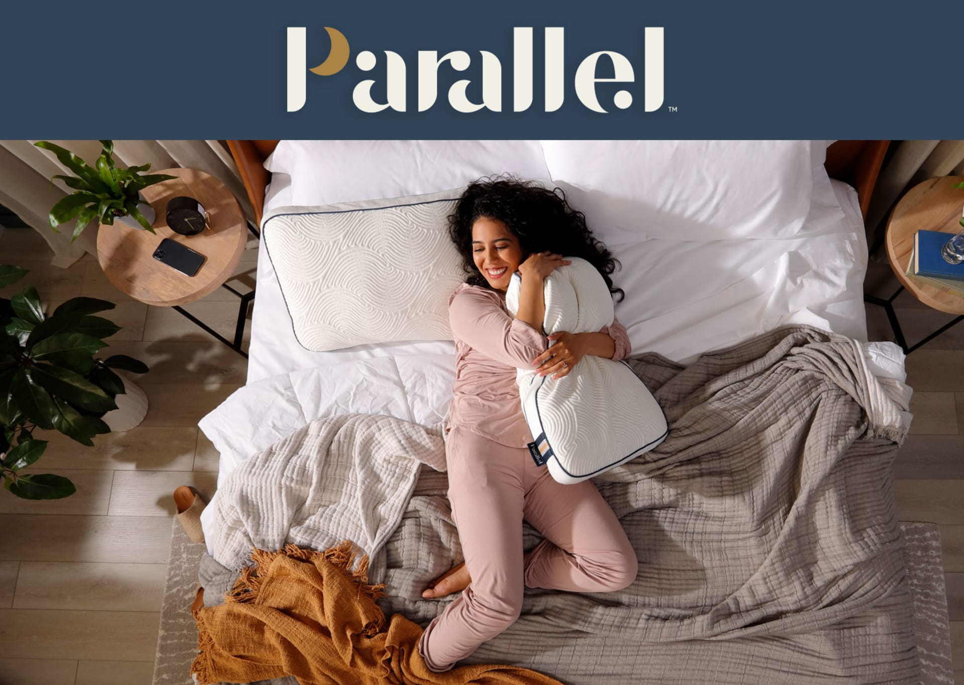 Woman laying in bed snuggling parallel pillow