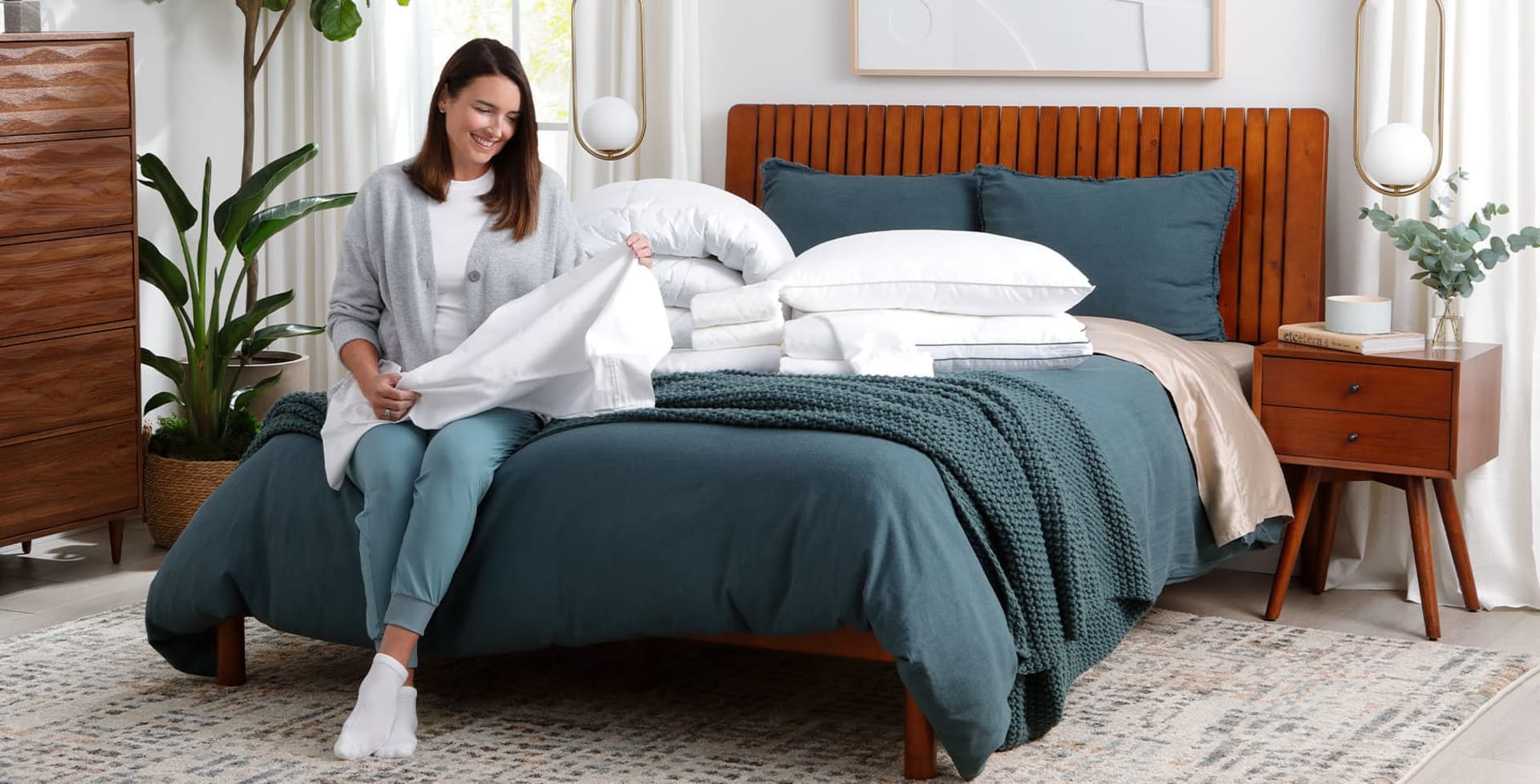 Woman with sheets and pillows on bed