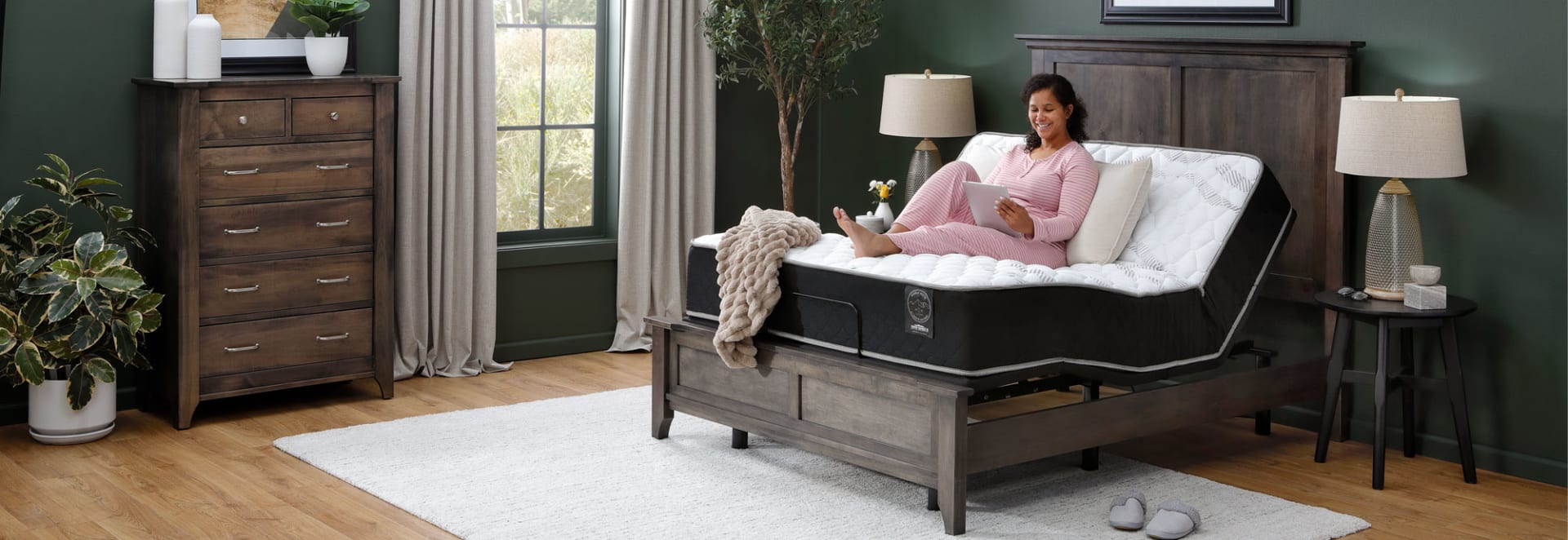 Woman Sitting on Buena Vista Mattress on Adjustable Base in Bedroom