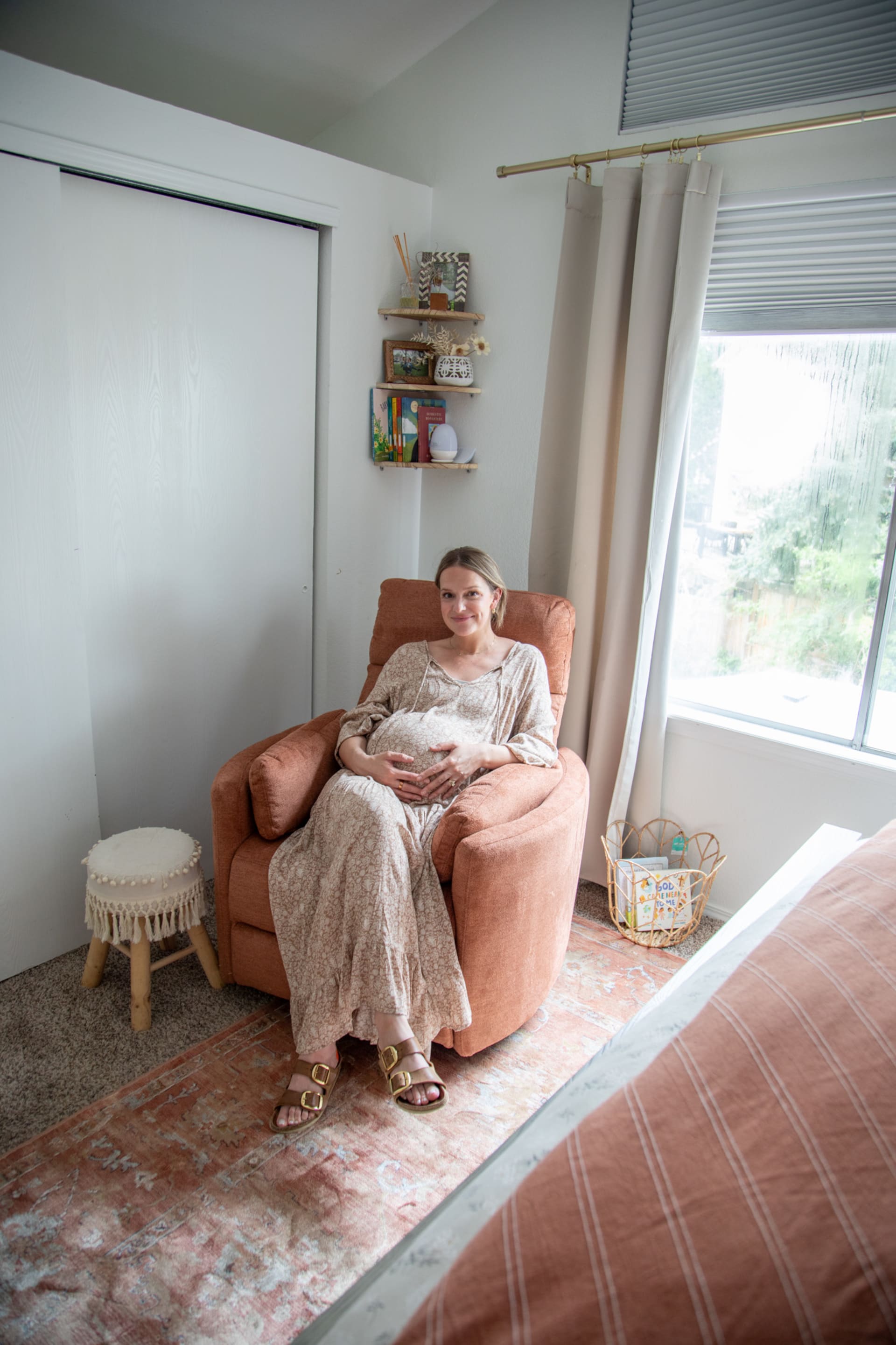 Real Spaces host Whitney in her bedroom enjoying a recliner chair