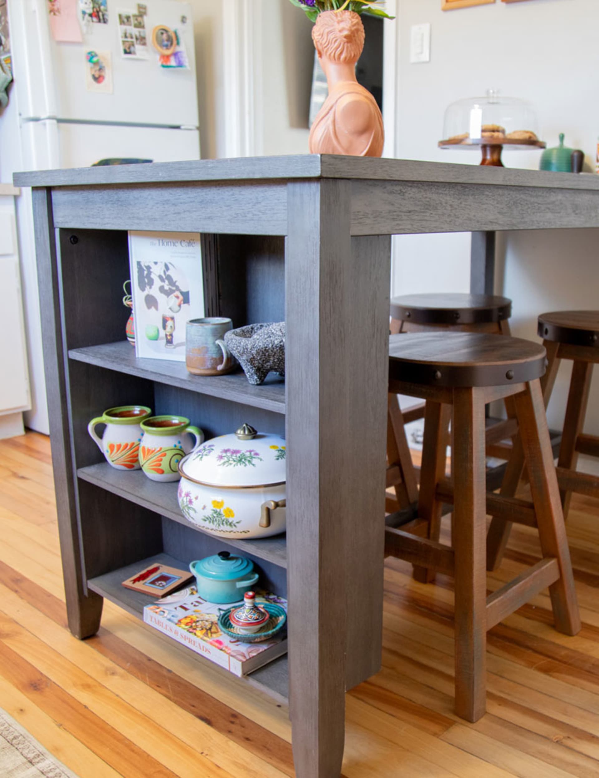 Grey wooden counter height dining table with shelf storage with eclectic western kitchen wears