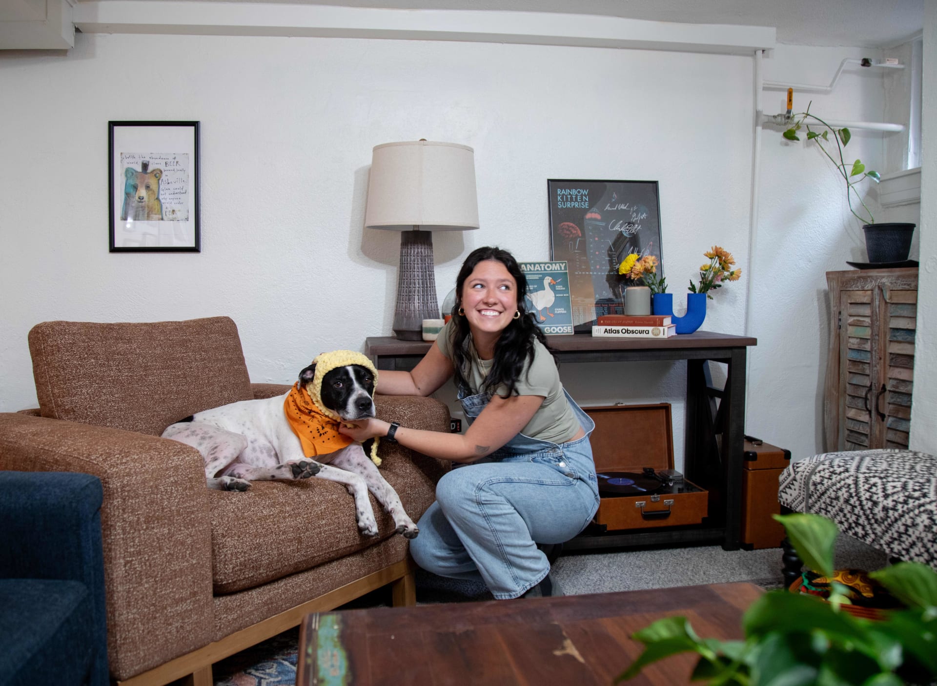 Shot of Mackinley with her dog posed in the Laguna Chair in her maximalist living oom