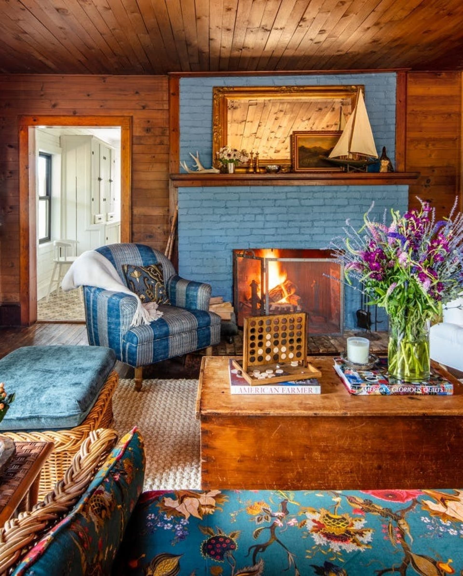 A coastal sitting room with blue chairs and wood coffee table