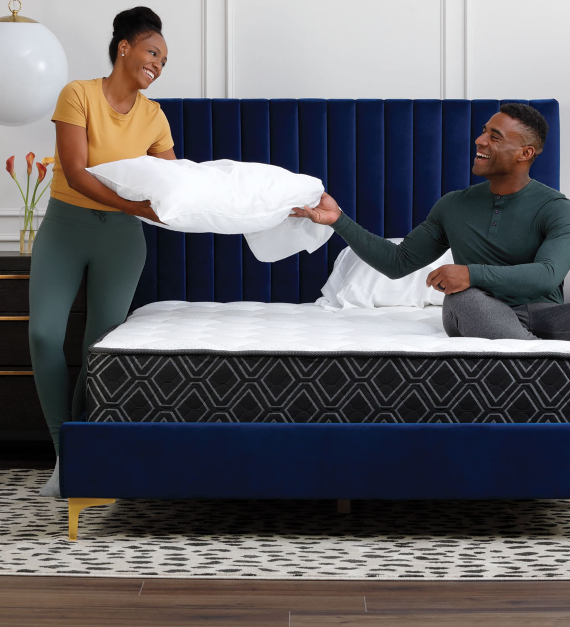 Couple Making bed with Doctor's Choice Hybrid Mattress
