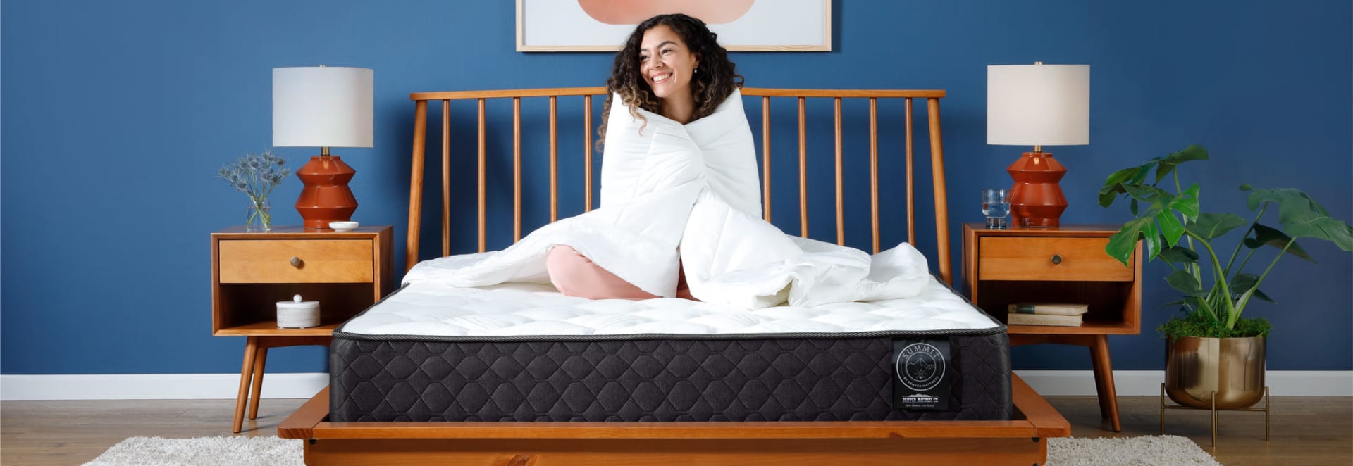 Girl Sitting on Summit Mattress in Bedroom