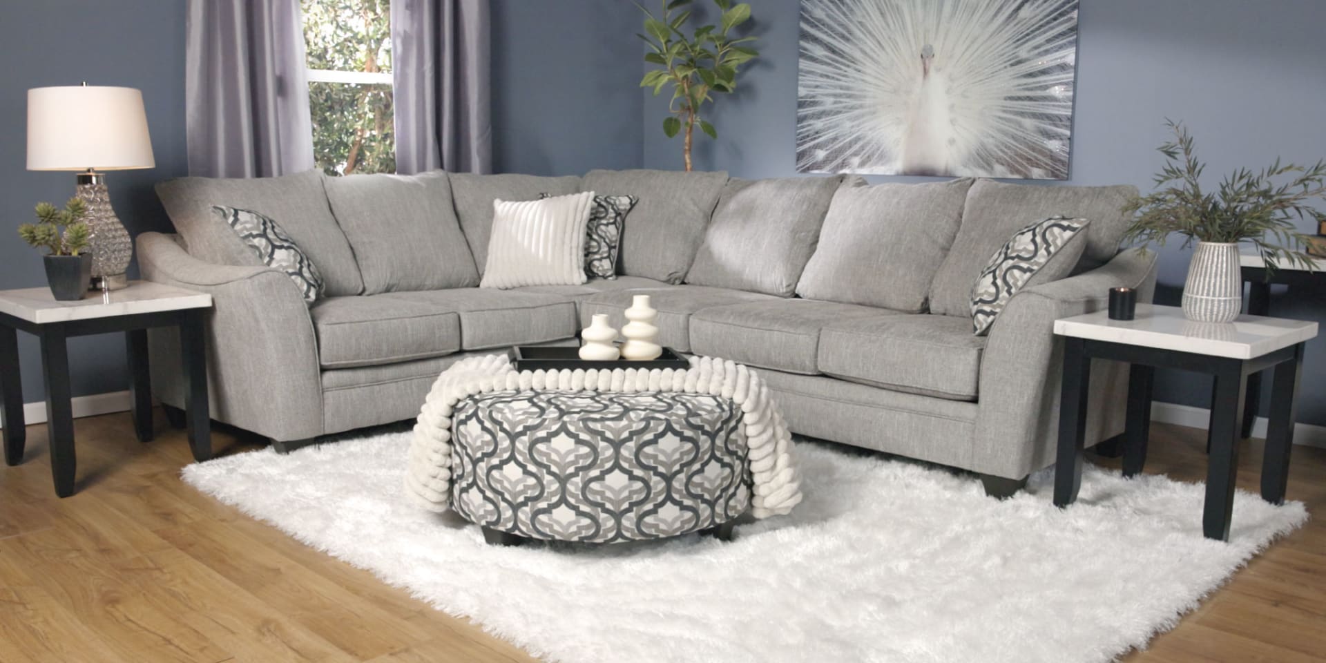 Mainstay Sectional in blue room with end tables and lamps