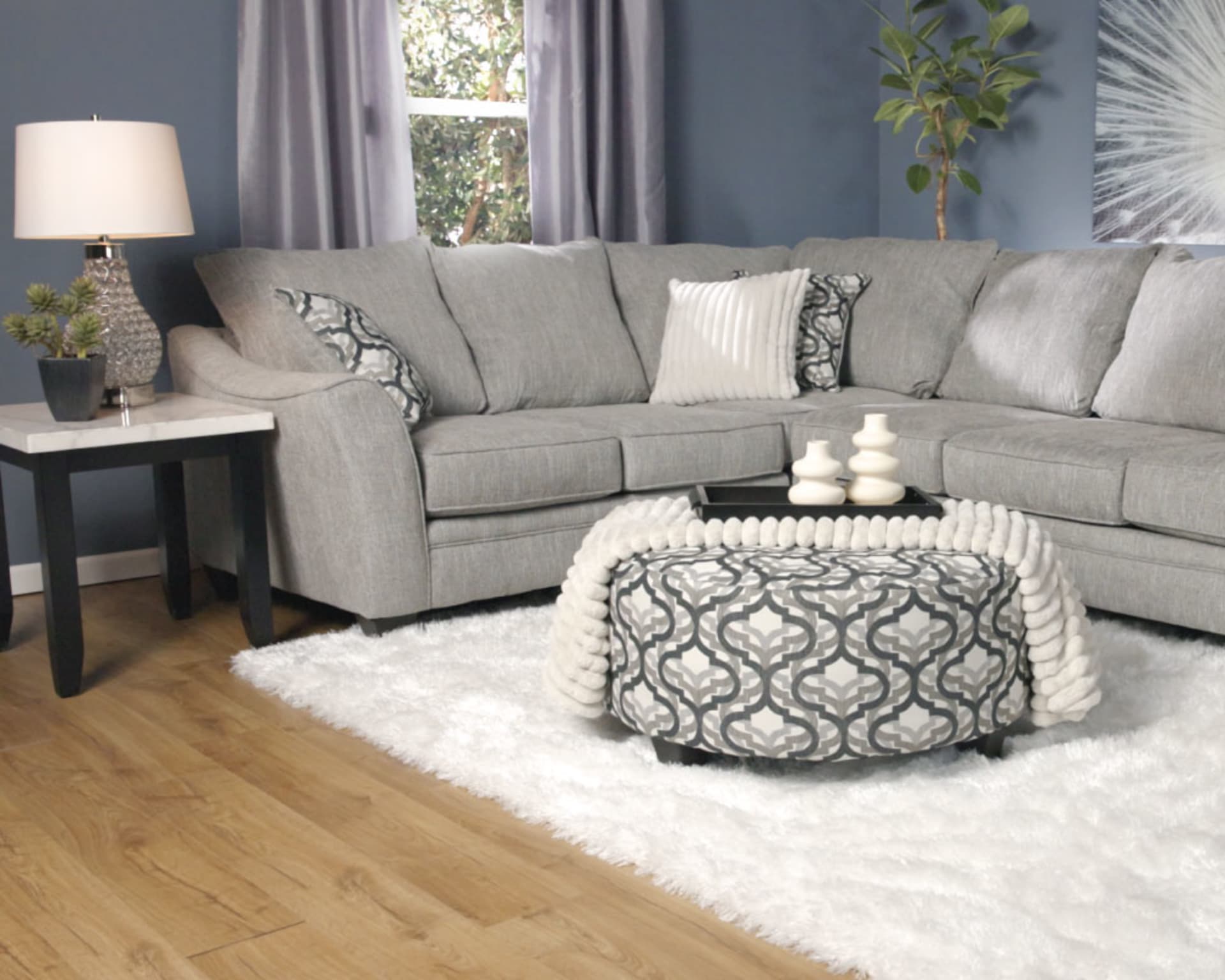 Mainstay Sectional in blue room with end tables and lamps