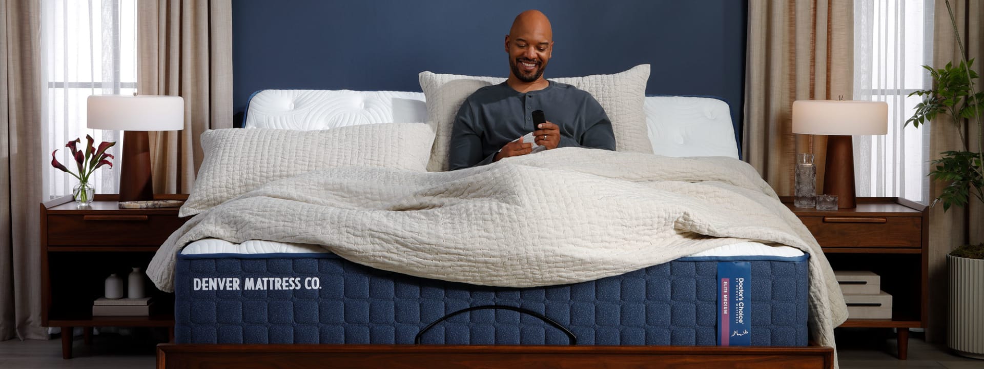 Man Sitting on Doctors Choice Elite Mattress on Adjustable Base