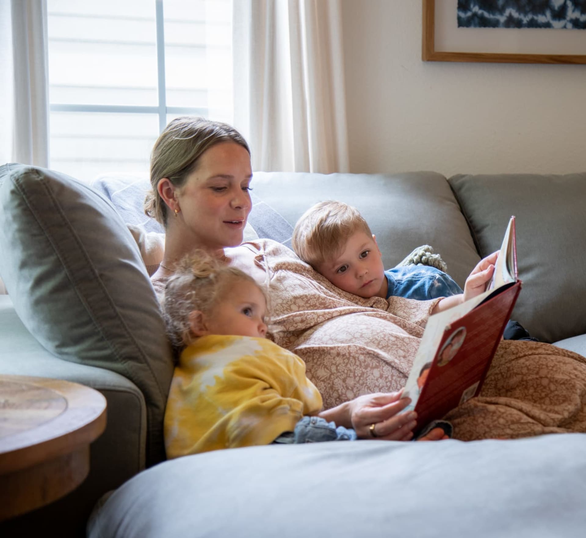 A family reading together atop a modern modular sectional