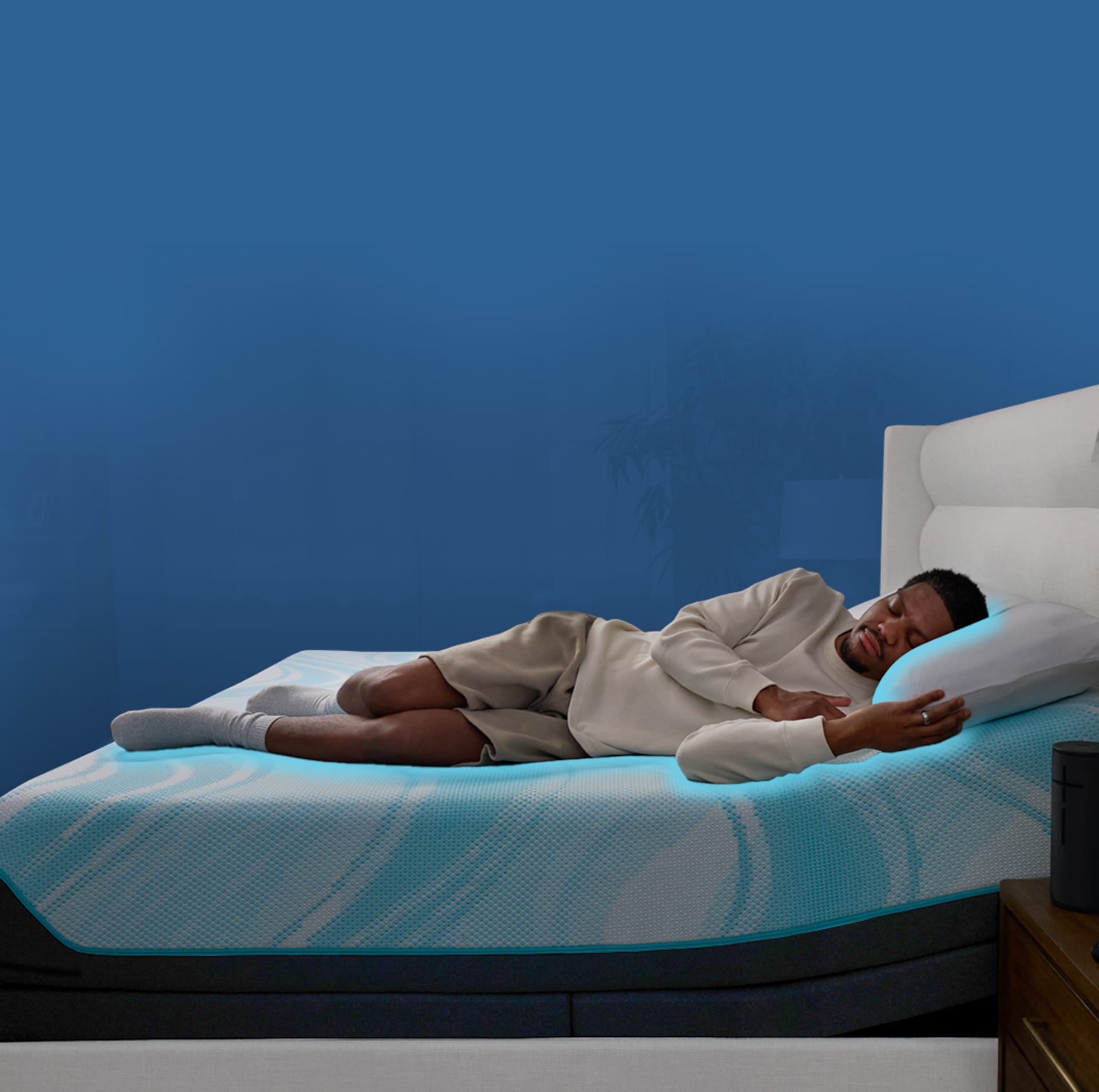 Man sleeping on Tempur mattress with blue background
