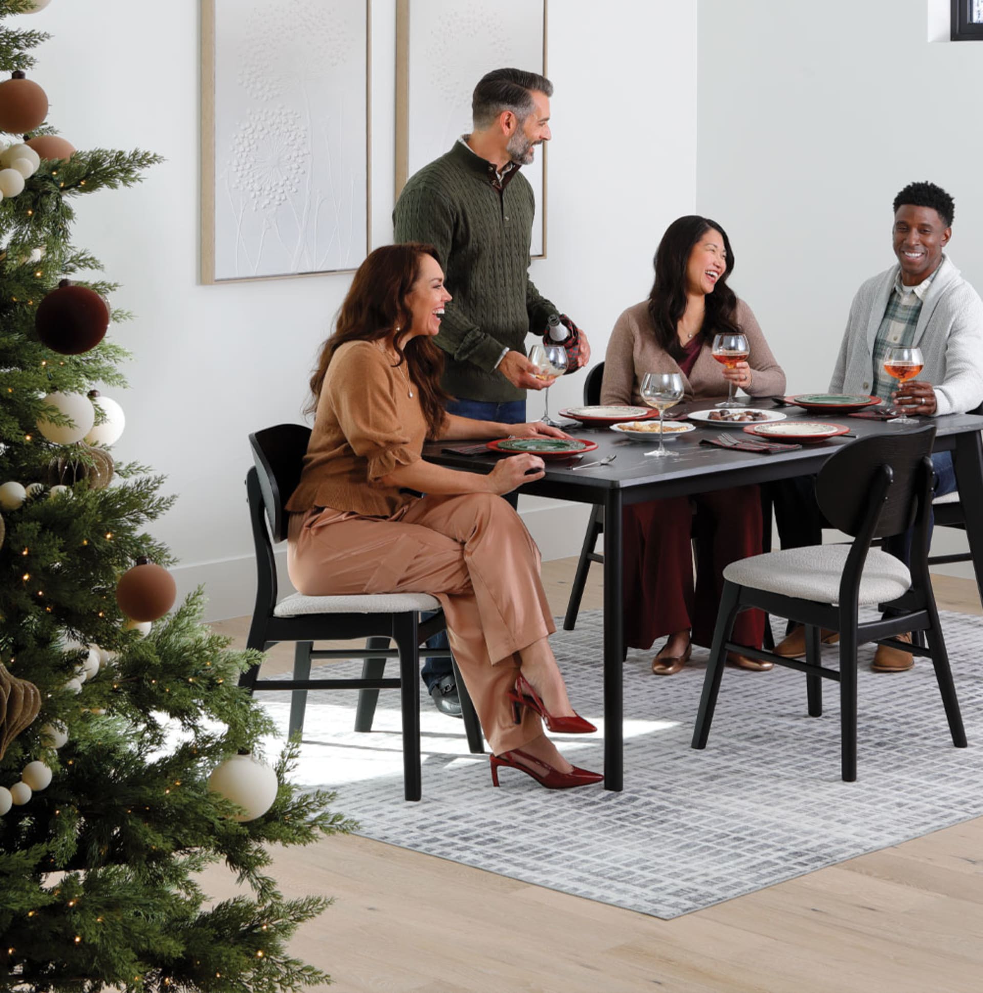 Friends gathered around Dark Stone top table in dining room decorated for Christmas