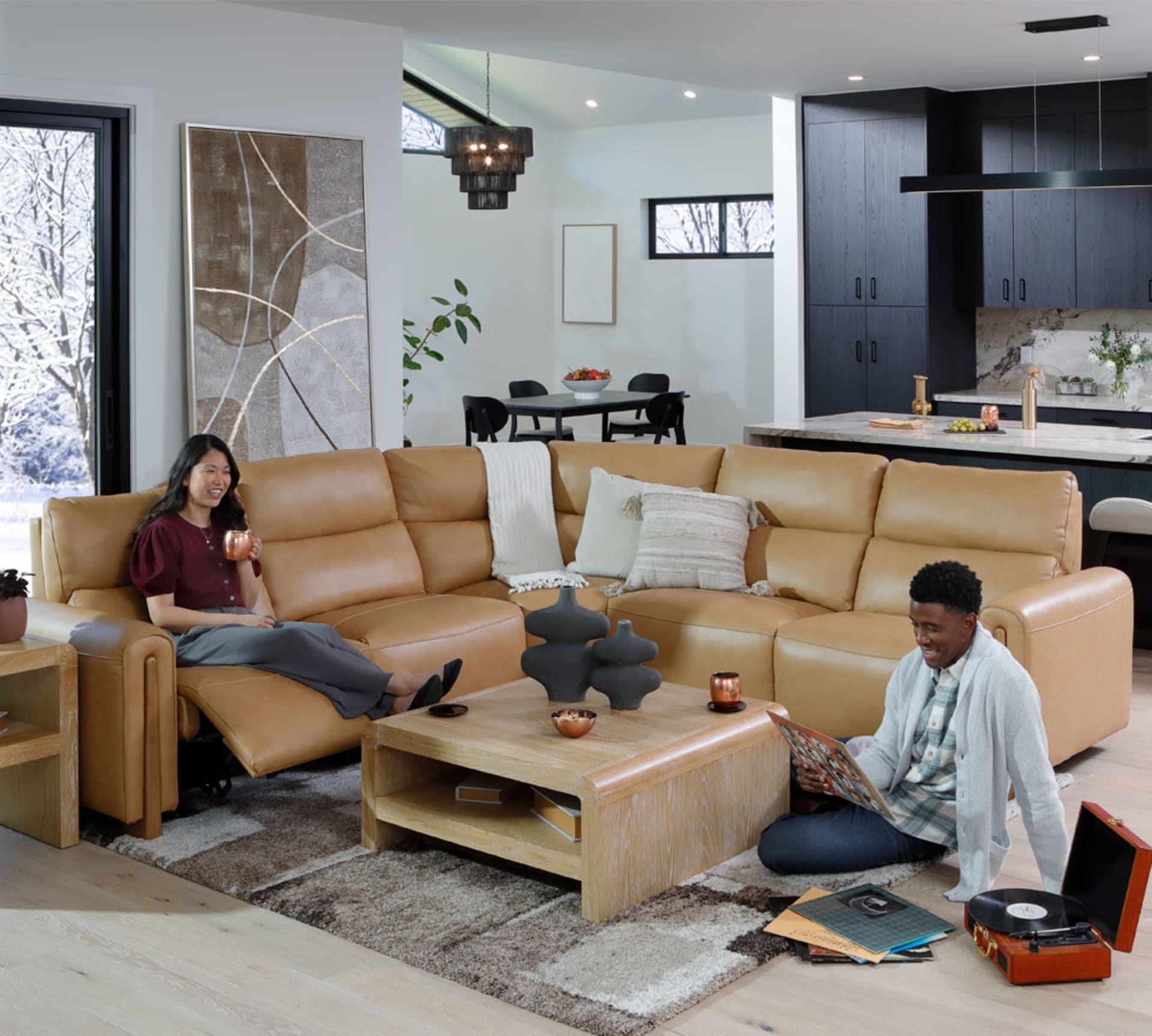 Couple listening to records on Camel Colored Leather Sectional with Stylish Wooden Accents in Living Room
