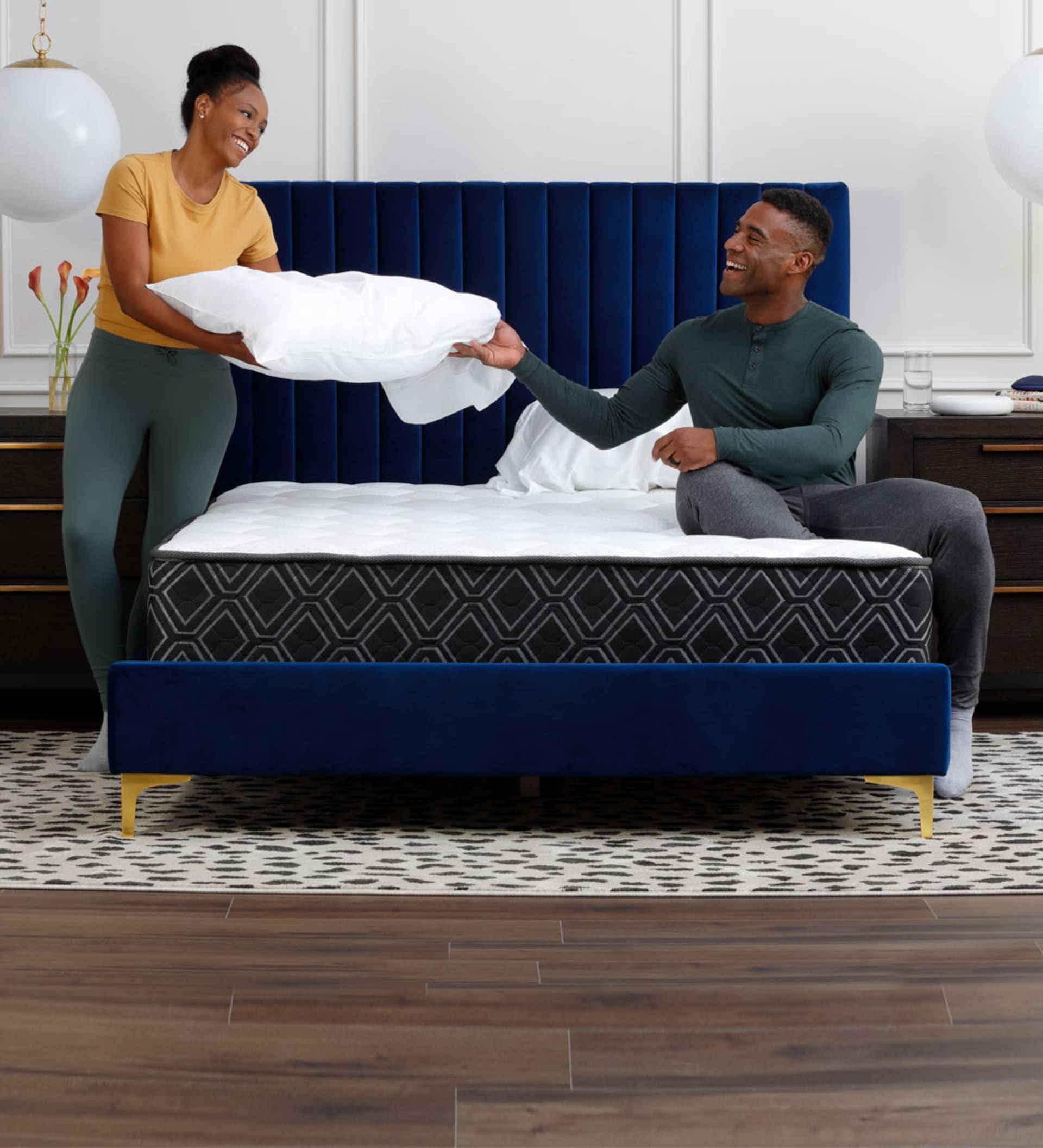 Couple in Bedroom Making a Doctors Choice Hybrid Mattress Bed