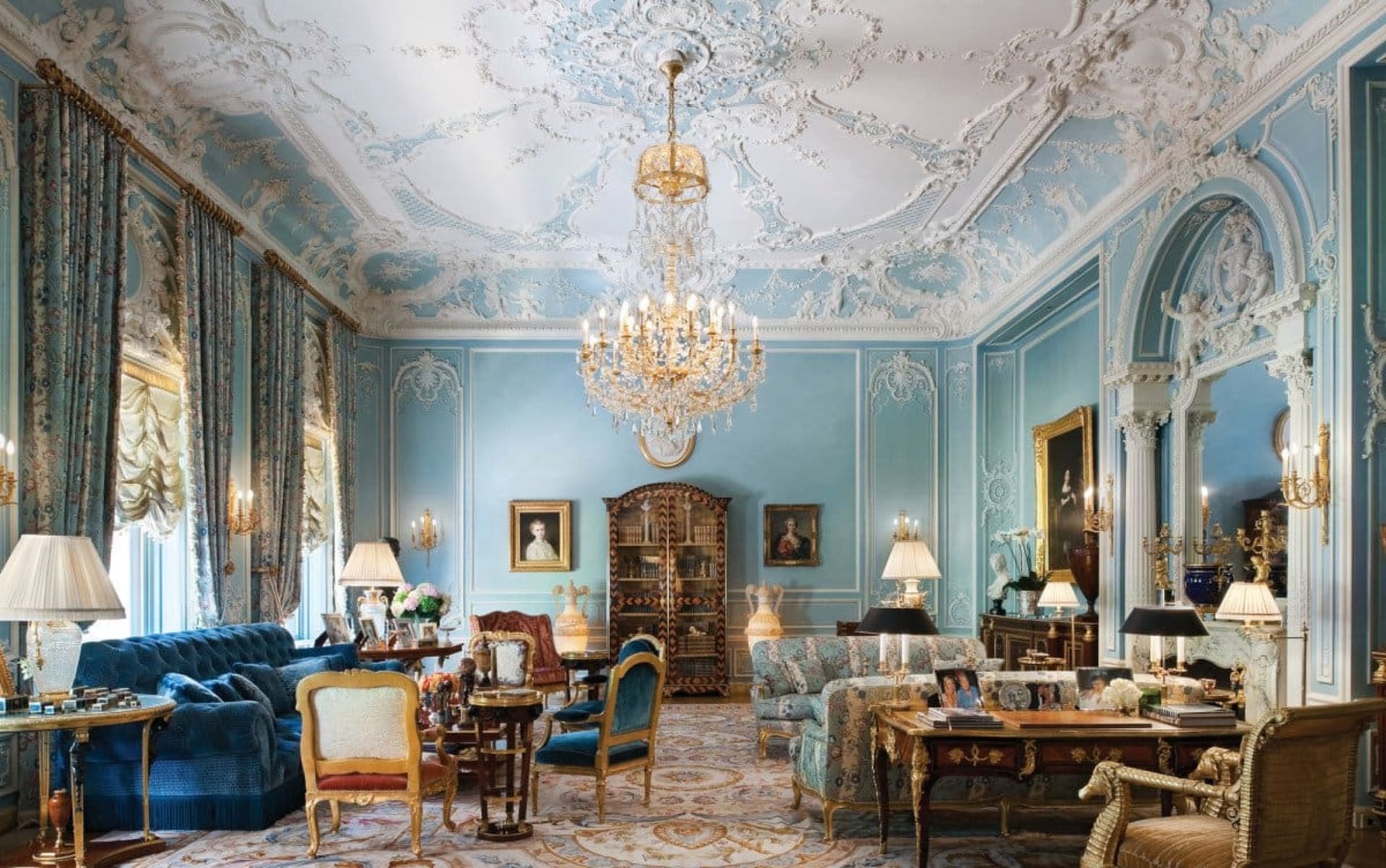 Victorian living room with rich blue color palette and gold accents