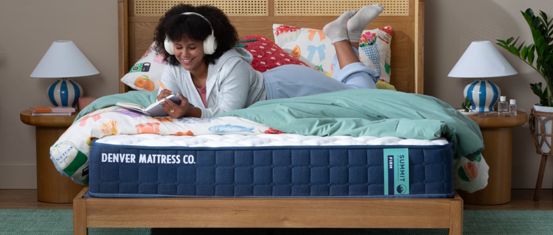 Woman Laying on Summit Factory Direct Mattress Journaling and Listening to Music
